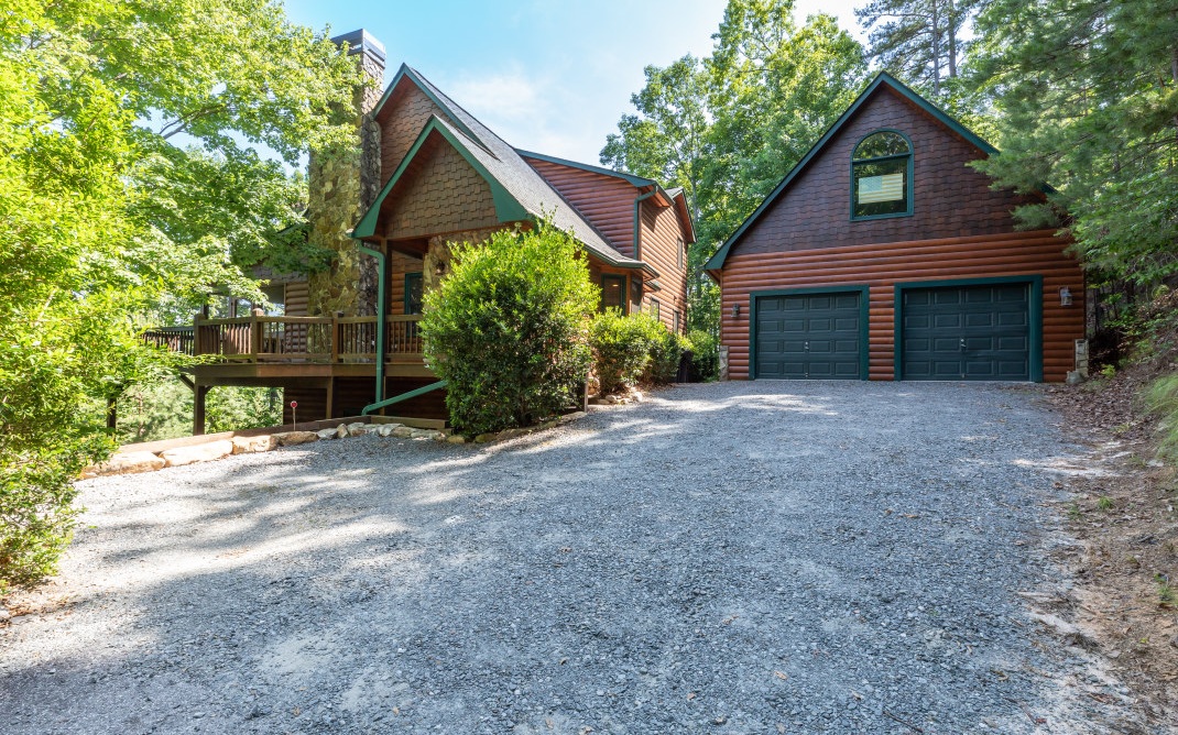 This GORGEOUS HOME defies the label “cabin” by way of space, yet has loads of cabin features i.e. wood paneling, stacked stone fireplace, exposed beams, log mantle, lots of natural light flowing in, & long range mountain views! Main floor features open concept LR/DR/Kitchen w/ double French doors opening onto covered deck, large owner’s suite & en suite w/ dual sinks, laundry closet, & private access to covered deck. Upstairs features loft sitting area, huge vaulted BDRM w/ attached sunroom, en suite w/ walk-in shower, dual sinks, & large walk-in closet. Terrace levels offers 3rd full-size studio bedroom w/ kitchenette, attached LR, and French doors opening onto private deck w/ hot tub. Large bonus room across from studio BR. Furnished minus personal items plus hot tub & pool table—available via SBOS. Make this your primary or secondary home. Move-in ready!