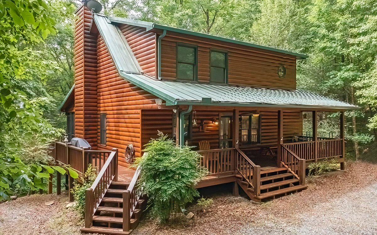 This Private, Peaceful Retreat with a 2BR/Large Loft/ 3BA Log Sided Cabin, sits right in the middle of 3 acres nestled among the Hardwoods, Hemlocks & Fluffy ferns. This inviting & immaculate cabin offers an outdoor relaxing experience from the screened-in porch to the hot tub porch. The cabin's interior offers an alluring “Cabiny” feel, full of charm & character with the perfect Mountain Décor & a lovely, stoned fireplace with gas logs (or can use as woodburning) located in the spacious Great Room. In addition to the 2 bedrooms & baths on the main & upper levels, there is a spacious loft on the upper & a full finished basement offering fun time in every room from the pool table, darts & air hockey to your very own theater room with actual theater seats. Just bring the popcorn! This entire property has a special ambiance W/seasonal Mtn views waiting for you in less than 15 minutes to downtown Blue Ridge.