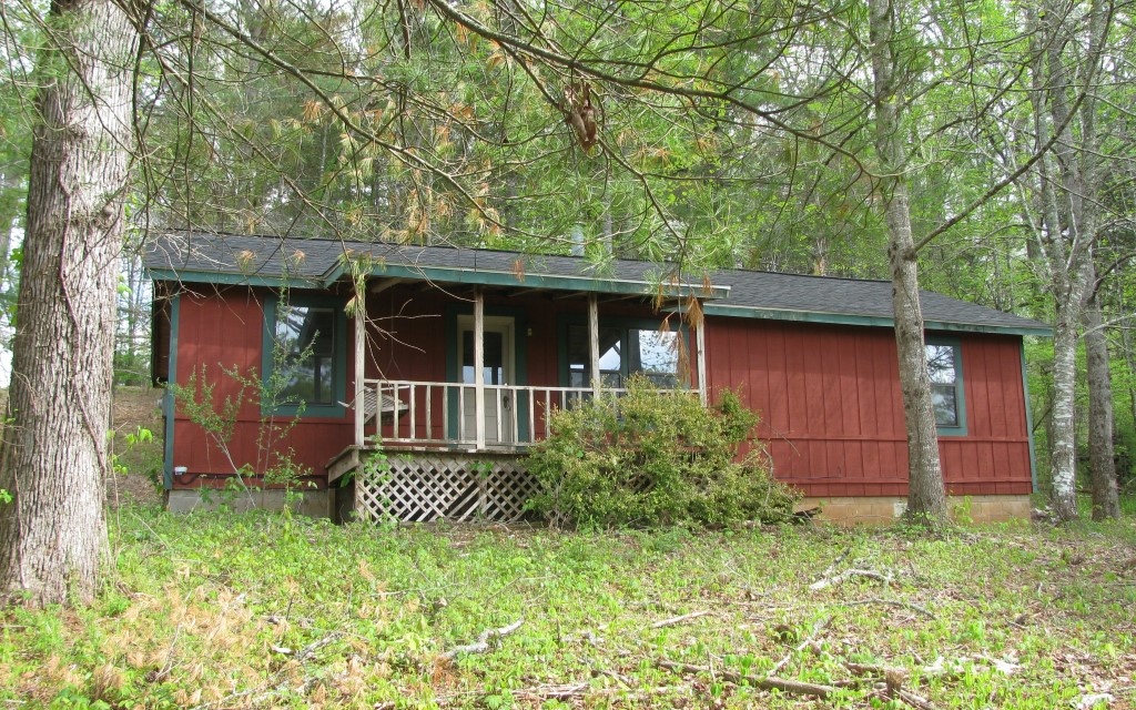 **One level older original cottage on 2 lots for a total of 2.21 acres**Has very good view potential with some tree clearing above the cabin**Cabin has original wood floors, some original wood walls, front porch with valley and mountain views**has wood stove for heat, no HVAC**Property is deed restricted but is in terrific location close to downtown Young Harris, Young Harris College and Brasstown Valley Resort and Golf Course**
