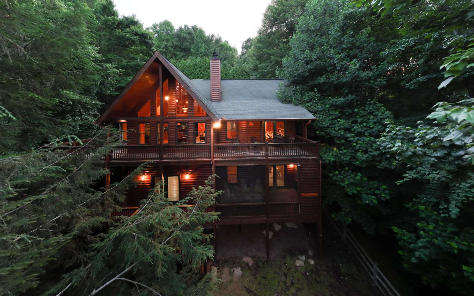Picturesque mountain views in an exclusive Blue Ridge neighborhood. This upscale cabin is surrounded by mature hardwoods, providing ultimate privacy. Situated on a 3 acre lot w/ 4 beds & 4 full baths, there is room for the whole family. The soaring ceilings and large fixed glass windows allow natural light to fill the home. On the main level you will find an open concept kitchen & living room & the master suite, featuring a stacked stone gas fireplace. W/ layered, long range mountain views, you’ll find yourself wanting to spend all your time on the porches! The terrace level offers an additional family room, screened porch w/ outdoor fireplace & stairs leading to the fenced yard. Cohutta Ranch Subdivision offers gated entry, a large pond, a 6-stall horse barn & fenced pastures in the heart of the Cohutta Mountains. Being sold turn-key, this incredible cabin is ready for you!!