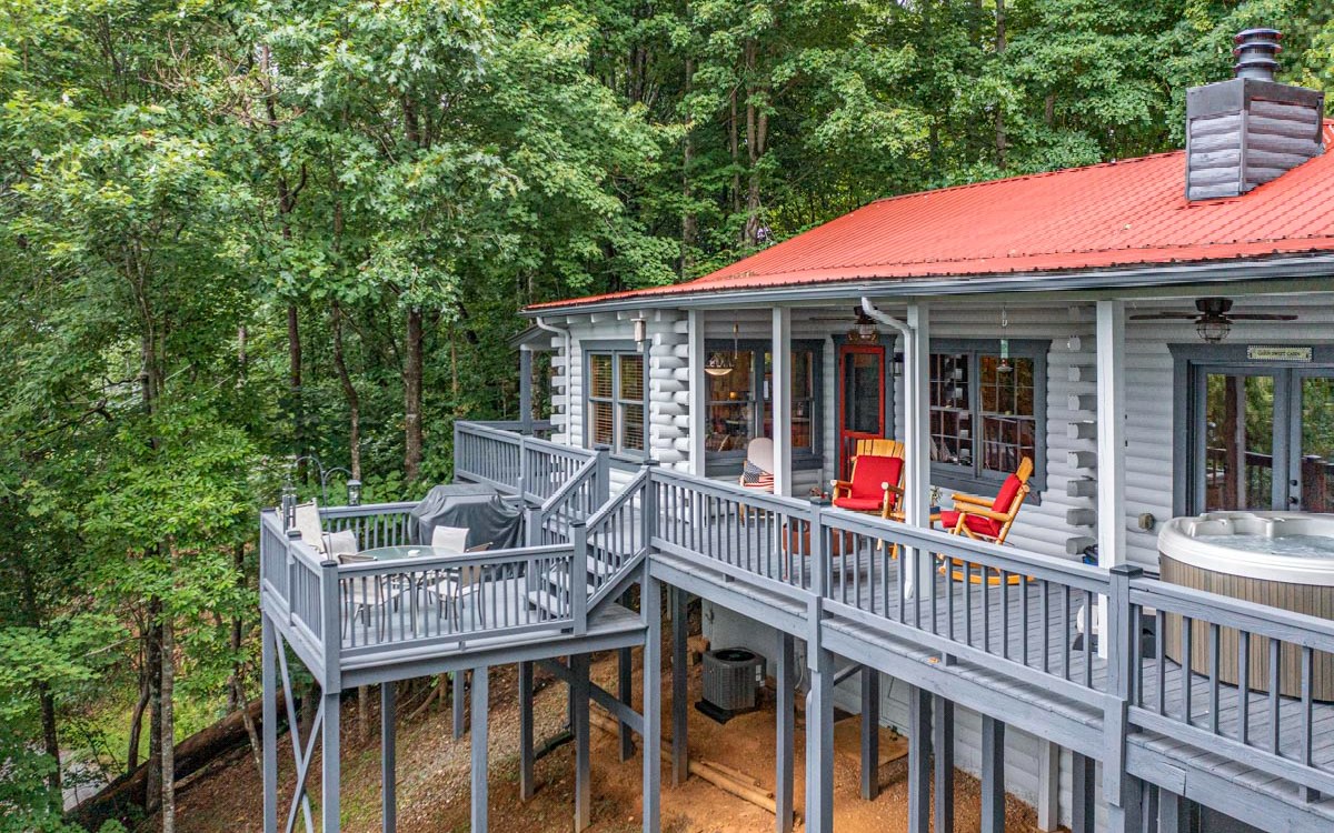 If peace and serenity are what you are longing for, look no further, this cabin has expansive year around mountain views, Large deck to enjoy the scenery, the 4 person hot tub stays - which means you need to get ready to relax and enjoy. The home has a circular driveway, plus a carport. Located 12 miles to Ellijay and 6 miles to Blue Ridge and only 1 mile off of Hwy 515. Cabin was professionally painted in 2021, very well maintained and boasts 12-inch pine floors. Good cell service, reliable high-speed internet and HDTV. Open concept Living/Dining/Kitchen area. This cabin would be perfect for short term rentals or keep it all to yourself and enjoy mountain living at its best. It has never been on a rental program. Some furnishings available with acceptable offer.