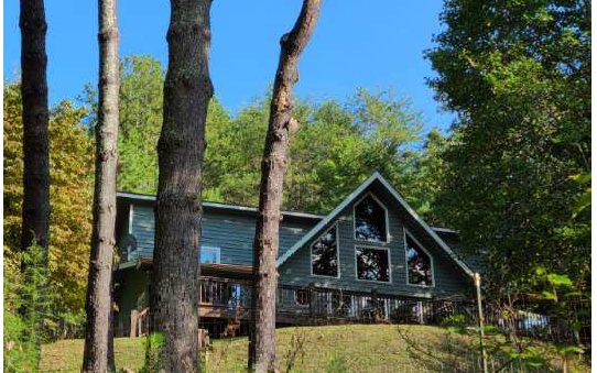 This mountain chalet home offers it all! It’s conveniently located between the mountain towns of Blue Ridge, Murphy, Blairsville, and McCaysville, and within a short driving distance to local waterfalls and mountain gorges, and the beautiful Lake Blue Ridge. Nestled on an acre with end of the road privacy; you’ll get a feel for the fresh mountain air while you stargaze under the night sky around the stone fire pit while gathering with friends. String your lights and hang your hammock under the trees or start your own mini farm with the custom chicken coop and run. You’ll have plenty of space for the whole family or for rental use in this 4/2 with added bonus room that would make the perfect nursery, office, or hobby room! The upstairs is a full owner’s suite overlooking the entertainment area complete with spacious closets, reading nook, and wifi-enable spa tub. Enjoy the colorful sunsets out of the oversized windows in your very own private mountain retreat. Upgrades include: encapsulated crawlspace w/ dehumidifier, 8x16 double lofted shed with bonus custom built-in workbench and lumber loft, stone fire pit, custom chicken coop and run, new microwave, and more!