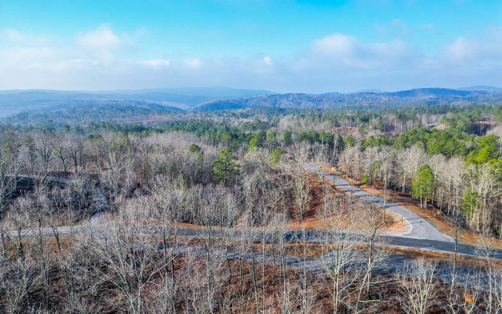 Beautiful Year-round mountain views can be had at this spacious 3.31 acre lot. From this central location you can be in either Ellijay, Jasper or Chatsworth in about 15 min. There is a nice gentle house site with the property sloping downward behind it. Gravel drive access is already in. The community of Creekside Crossing offers a gated entrance, lots of hiking and ATV trails and relaxing creekside parks and access on Talking Rock Creek. Seller is unsure of yearly HOA dues and is looking into it.