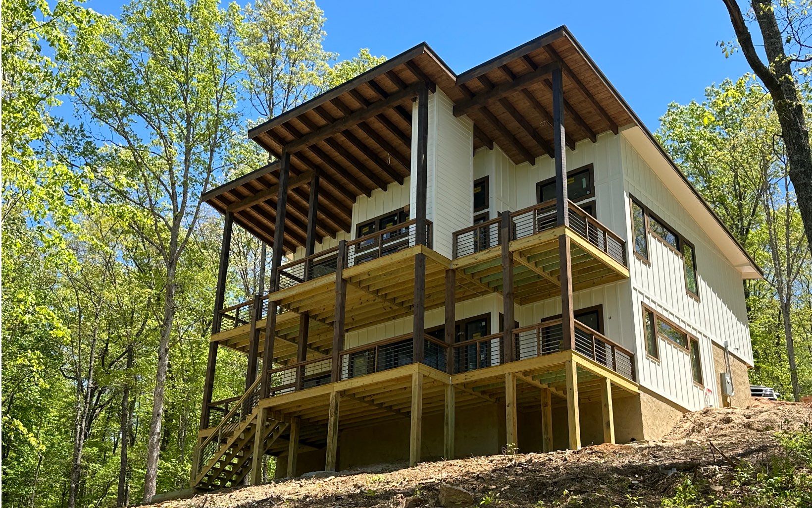 Pre-Construction...Mountain Modern creekfront cabin located within 5 min of Downtown Blue Ridge! Sleek, Bold accents meeting modern rustic design creates the ultimate cabin for the most discerning buyer! Open great room w windows galore, soaring ceilings, lavish stone fireplace, massive wood beam accents & the best in lighting & finishes! Combination of wood, stone & drywall add just the right amount of texture! The main level boasts 2 master bedrooms, a butler's pantry, tile walk-in shower & great closet space. Main level deck will feel like part of the living space as the two combine giving it the most adequate entertainment area alongside the outdoor fireplace. The terrace level features stained concrete flooring, wet bar, rec/bonus area as well as 2 more bedrooms & baths. Again, the outdoors will be incorporated in to the space allowing you the ability to enjoy your useable creekfront acreage! POWERLINES TO BE REMOVED so there's nothing blocking your view of the creek or invading your space. Easy access, private lot, SHORT TERM RENTALS ARE ALLOWED & HIGH SPEED INTERNET AVAILABLE! Completion date projected for July 31, 2023.