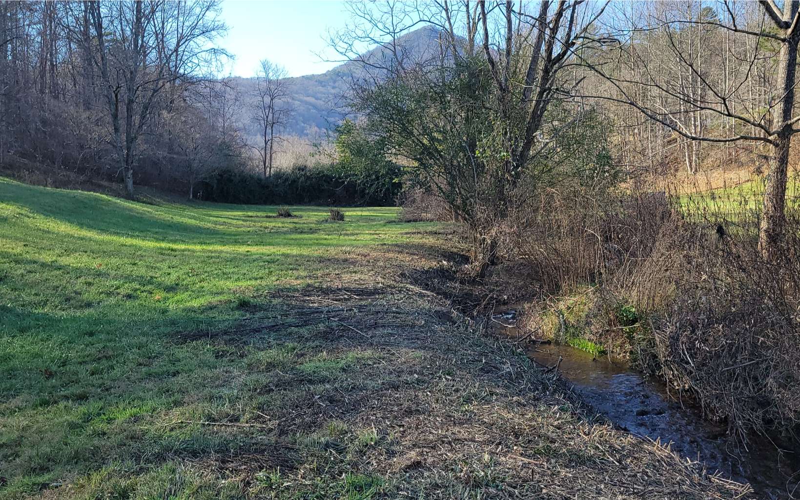 Build your dream home in the North Georgia Mountains! Beautiful building lot on small creek with about 300 ft frontage bordering front of property. Enjoy the mountain views. Sit down by the creek listening to the soothing sounds of the water while basking in the sunshine. On the lower corner of the lot you can see a view of Brasstown Bald, the highest mountain in the state of Georgia. Very peaceful setting yet still close to downtown Hiawassee for all of your shopping needs. Helen Ga is in the neighboring town just over Unicoi Mtn. Many Vineyards and area restaurants in the area to enjoy. 2 hours from Atlanta. The mountains in Georgia is the best place to live so this will be the perfect lot to settle down in your dream home!!!