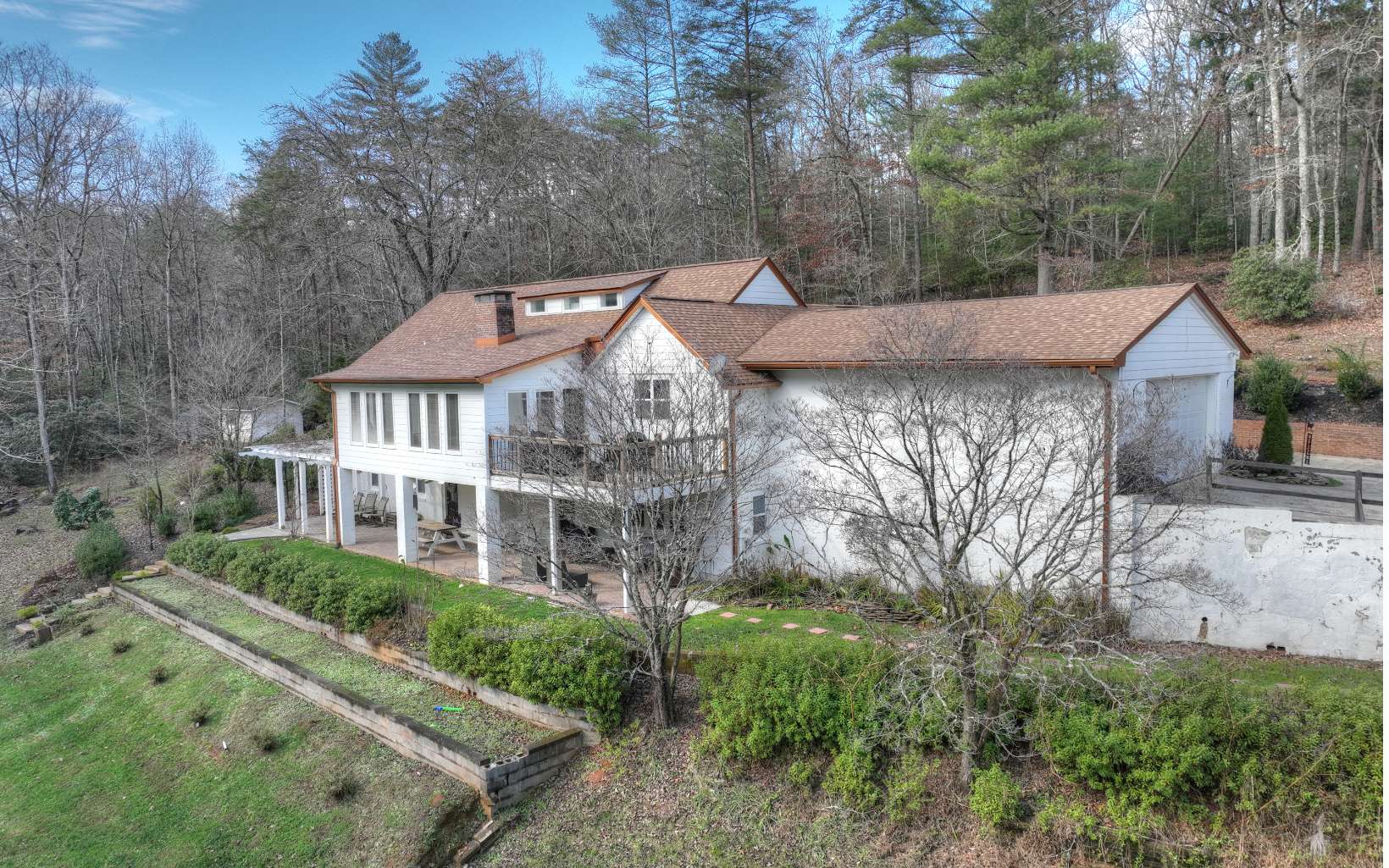 "European Farmhouse Feel" in the Mountains featuring almost 5,000 Sq Ft....."Built to Last"- 4-Sided "White" Brick w/Craftsman Accents on BIG Acreage (9.3 Acres). Beautifully Landscaped & Designed w/Terraces (Front & Back). 528' of "Cascading" Little Rose CREEK Frontage w/Shoreline Gazebo, Firepit & Pedestrian Bridge to access Your Acreage Across the Creek. WIDE OPEN Floor Plan w/Shiplap Walls & "Fossilized" Bamboo Floors. Impressive Kitchen w/Cathedral Ceiling (WOOD beams) Wall Ovens, Solid Surface Counters, Gas Cooktop w/Pot Filler & Huge Entertainment Island w/seating for 6."Centerpiece" Brick Fireplace between Living Rm & Sun Rm (Quality Crank-out Windows). Huge Dining Space w (2) "Bay Window" Extensions. Master Suite w/Trey Ceiling, Tile Showers (frameless door), Tile Floors, Double Vanity Marble Tops & Slipper Tub (Waterfall Faucet). Another Guest Bdrm Suite on Main Flr. 2 Car Attached Garage. Upper Floor w/Dormer Windows/Ceiling Lines, Open Sleeping Loft +(2) Guest Bdrms & Full Bath (Tile). "Walk Out" Terrace Level w/Bonus Rm, Billiard Area, 2nd FULL-SIZE Kitchen, (2nd) Huge Dining Area, (2) Guest Bdrms, Jack & Jill Bath (ALL Tile & Marble). "Paver" Patio w/Arbor & "Stone Slab" Steps Leading to Level Shoreline along Rose Creek. Long Driveway Approach for a Very Private Setting.Copper Soffit, Facia & Gutters