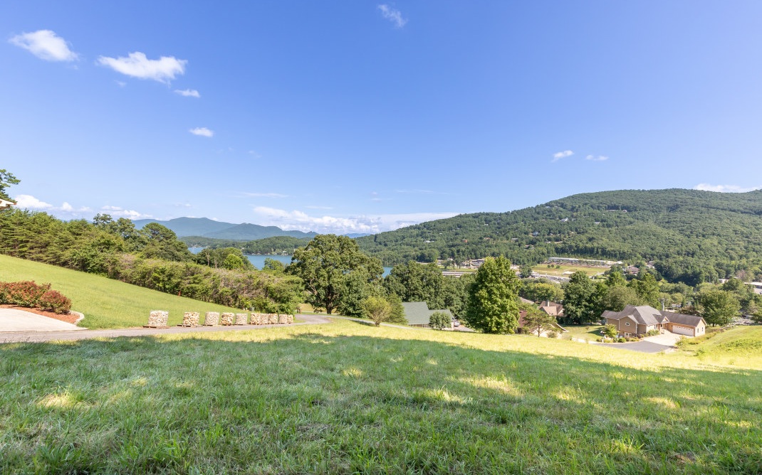 Imagine evenings on the back porch of your new custom-built home which sits on the top of the gentlest hill with panoramic views of Lake Chatuge, the marina and the mountains. This is God’s country for sure! Located convenient to Hiawassee, Hayesville, or Blairsville, this .9-acre lot has been perked for septic and is just waiting for the next step towards hosting a beautiful mountain home. Residents in this community enjoy underground utilities for unobstructed views and clear landscapes as well as paved community roads and city water hookup. The Ridges Marina, a full-service marina owned and operated by The Ridges Resort on Lake Chatuge, is right across the street and offers boat slips, dry storage, watercraft rentals, and two fine dining options, making your new neighborhood the perfect playground for family and guests. And of course, yourself and your new “mountain life”!