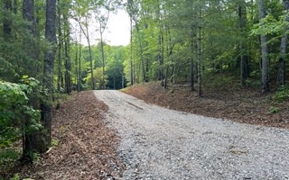 Looking for that gentle laying wooded lot close to Downtown Blue Ridge? Come see this one. Gravel driveway in, lot cleared, foundation digging has began. Owner decided not to build, his work is your gain... Tucked in the woods off of a circular driveway this property is waiting on your new home.
