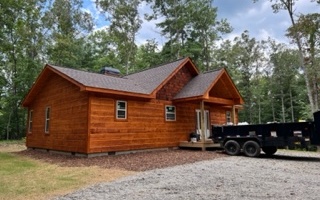 New Construction Cabin nestled info hardwood forest! Almost complete 2br/2ba with super easy access off main roads with no steep mountains to climb offering level terrain great for kids or the fur kids! Coveted split plan with bed/bath on each side of spacious great room. Great room offers cathedral ceiling w/wood beams, large windows and double french doors overlooking back covered porch and back yard, stone wood burning fireplace, granite counter tops. Master suite offers walk in closet, plenty of windows for natural light, custom tile shower, and double vanity, granite countertops. Guest room also offers plenty of windows and direct access to 2nd bath. Laundry located just off entryway for ease of access. Covered front porch overlooking peaceful quiet setting.