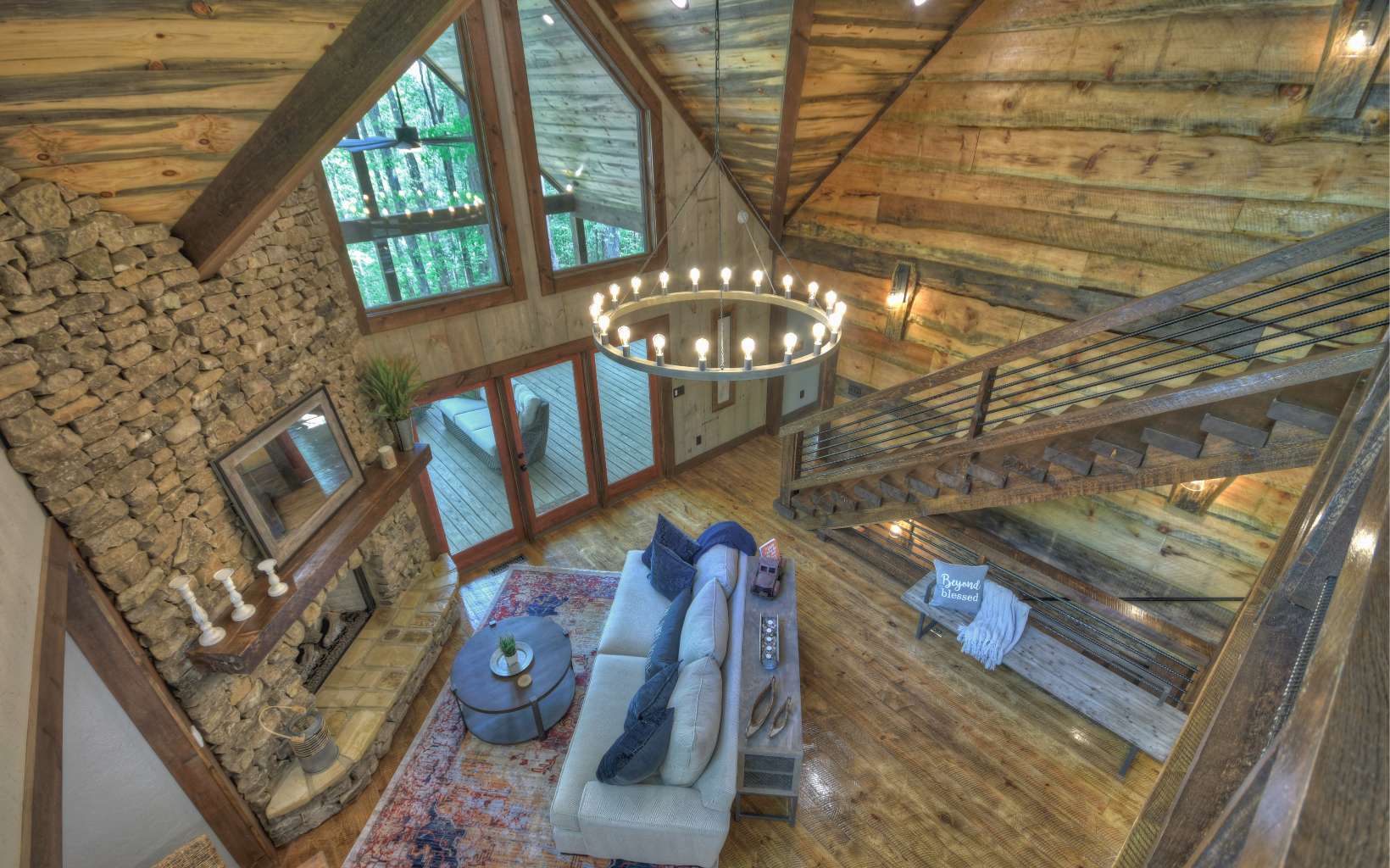 Beautifully designed and constructed by Marc Nicholson, this mountain masterpiece is sure to WOW you! You'll find a rustic mix of wood and sheetrock interior w/ granite countertops, custom stonework & hardwood floors throughout. Each of the 3 levels boast a private suite plus additional sleeping space upstairs in the large open loft w/ 2 sets of built-in bunk beds! The chef's kitchen offers an oversized island, Viking Appliances and farmhouse sink. An open concept floorplan allows room to entertain on the main level with French Doors that expand to a huge, covered deck w/ stone fireplace, outdoor living & dining rooms. Full finished terrace level also opens to a second expansive deck space. Located in the heart of the Aska Adventure Area with deeded access to Lake Blue Ridge, this property has established rental history & would make an incredible full time home or investment property!