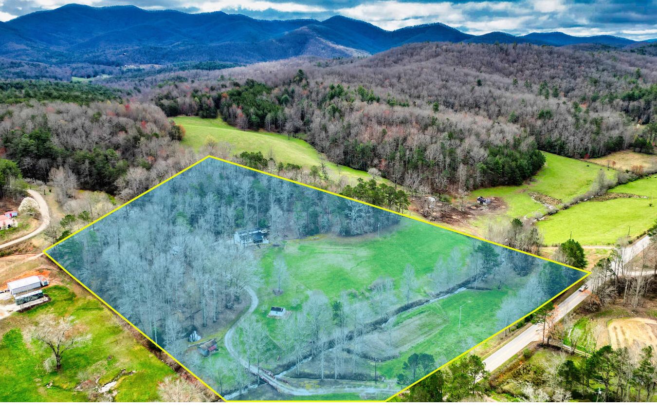 Motivated Sellers - Priced below appraisal amount! Serene 11.5+ UNRESTRICTED Creekfront acres in Union County with Mountain Views! Useable land - space for RV's and boats. Barndominium Style Home has an apartment upstairs that can be income producing, caregiver quarters or part of the flow of the house. Total 3 bedroom/3 bathrooms. Downstairs is all newer construction (2021-2022) with vinyl (LVP) flooring, acoustic barrier walls plus a covered screened-in patio and open deck. Property has year-round flowing Russell Branch Creek frontage, small pond, a forest with 2 trails, and a picnic/sunset deck at the top of property in back. Remote control entry gate for privacy. This home is move in ready and has been meticulously cared for. Selling Furnished.