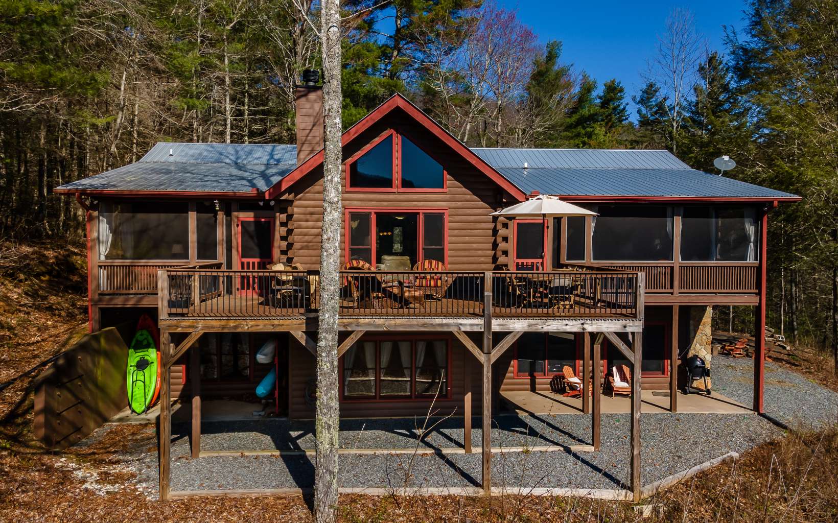 Looking for privacy, acreage, water frontage, and year-round views? How about an excuse to flip the SUV into 4WD/AWD and meander thru the hemlocks, rhododendron, and laurel to this well-maintained 4/3 cabin on 4.56 acres in the heart of 36,000 acres of Cohutta Wilderness? 357 ft of small creek frontage cascading thru the property to join the rushing, noisy waters of Fightingtown Creek below can be heard from any room in the house. On the main level, find an open floorplan w/master suite, 2BR w/shared BA, laundry, two screen porches, oversized deck perched above the crystal, and clear waters that originate in the Cohutta’s and sing to you year-round. All wood interior, plus fully finished basement with wet bar, additional BR/BA, “drive under” garage, and firepit. The driveway is partially paved, but 4WD/AWD is required