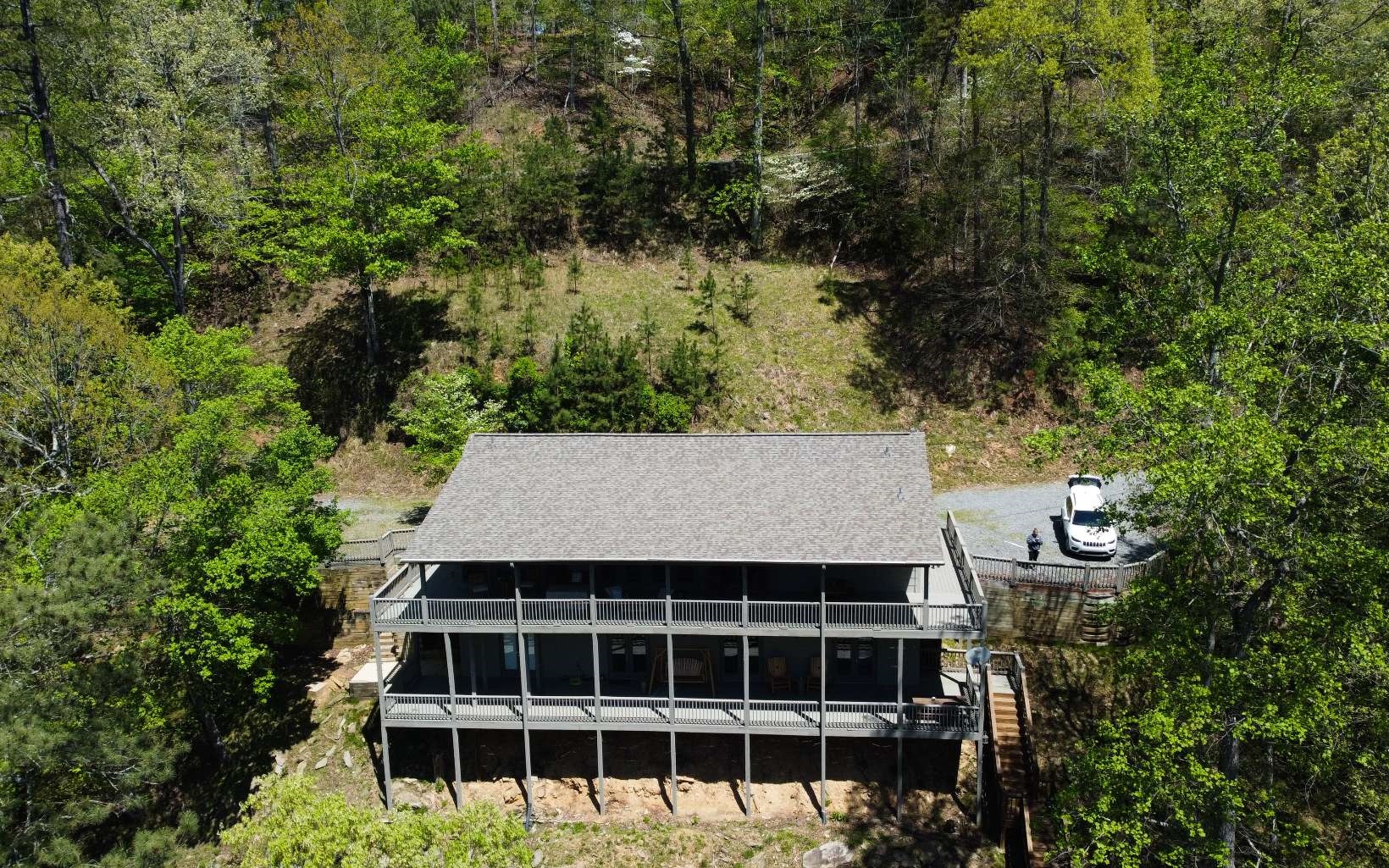 ROARING RIVER-FRONT RETREAT IN THE NORTH GA MOUNTAINS! This sizable and spectacular home will beckon you with MAJESTIC VIEWS and over 200 FEET OF COOSAWATTEE RIVER FRONTAGE. The STEPLESS ENTRY of the home’s main level opens to the fabulously flowing, OPEN-CONCEPT footprint, complete with gleaming hardwoods, soaring ceilings, and generous windows, allowing natural lighting to infuse the spaces.The living room is adorned with a romantic, floor-to-ceiling FIREPLACE as the room’s focal point, which is beautifully offset by handsome BEAMS. The bright and airy kitchen features sleek, white cabinetry met with dazzling granite countertops, and stainless appliance package in place. Marvelous MAIN-LEVEL OWNER’S RETREAT with SPA-INSPIRED ENSUITE, including double vanities, jetted tub, and MASSIVE, WALK-IN TILE SHOWER with arched entry. The additional main-level bedroom is serviced by a full bath with gorgeous tile shower with seamless glass enclosure. The lower level is comprised of a generous GAME ROOM, complete with FIREPLACE and handy KITCHENETTE; 2 generously sized bedrooms; and 2 full baths with brilliant aureate hardware. This marvelous abode offers the natural beauty of the mountains and river without the decorating limitations of a traditional cabin. Expansive, WRAP AROUND DECKING is a storybook setting for entertaining and relaxing to the sound of RIVER MUSIC. Additional, RIVERSIDE SUNBATHING DECK is in place for summertime fun! Enjoy fantastic FISHING (trout, bass, brim, etc)