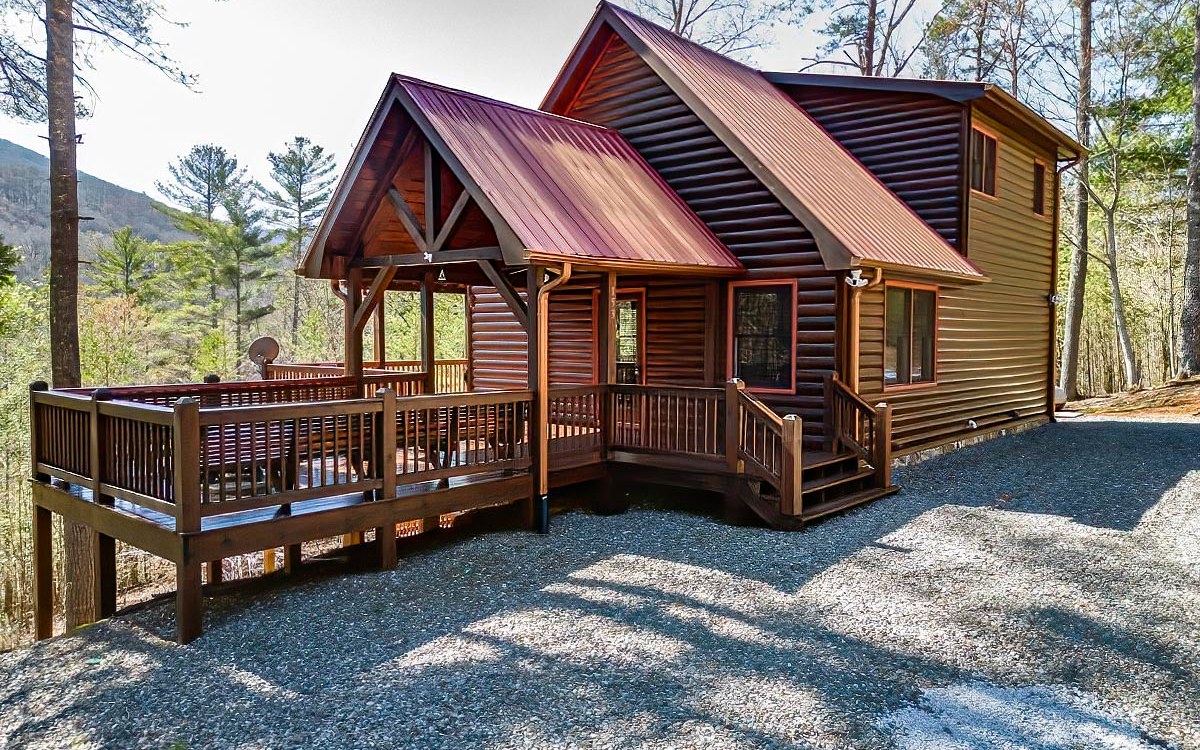 This Inviting & Immaculate 3BR/3BA Log Sided Cabin located just around the bend from 1000s of acres of US Forest Service & access to Little Fightingtown Creek, offers picturesque year round mountain views & pretty seasonal sunsets from almost every room & porch. Experience true mountain relaxation on the open deck with built in benches & a firepit or grab an Adirondack on one of the 3 covered porches. The Interior of the home comes furnished & offers an alluring “Cabiny” feel full of charm & character from the Great Rooms floor to ceiling stone gas log fireplace w/log mantel & 2nd Gas log fireplace in the terrace level family room, to the stone front breakfast bar w/live edge log counter top & live edge stairwell w/log railings leading to the upper Master Suite w/spacious Bedroom, Bath, Loft sitting area & sleeping porch offering the maximum mountain view. More of the cabin’s features include: Cathedral Ceiling w/beams in main living area, oak flooring through-out cabin, extended family room on terrace level; exterior terraced landscaped walk way and a Special Ambience that illuminates this perfect Mountain Beauty in the Blue Ridge Mountains.