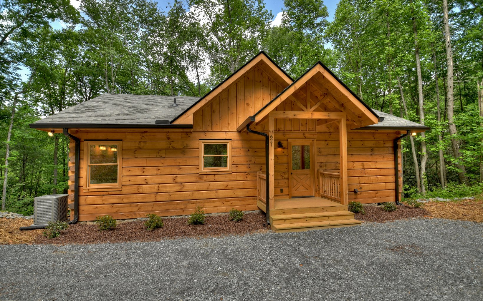 New log cabin sitting on Bucktown Creek with beautiful creek sounds. great rental floor plan. Popular split 2/2 with soaring greatroom and corner rock fireplace with gas logs, open to kitchen with custom cabinets. Wood floors throughout. Porch goes all the way across the back with plenty of space to enjoy the beautiful foliage and creek sounds.