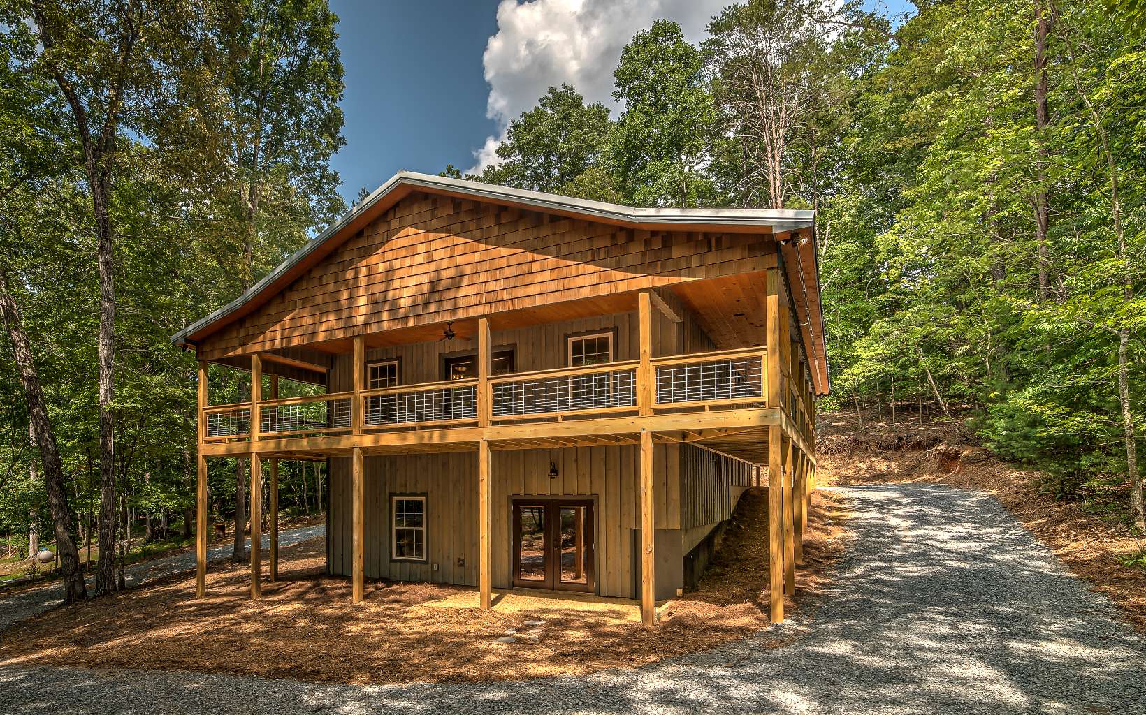 Check out this SUPER CUTE 3BR/2.5BA mountain cabin with numerous upgrades. This is not your cookie-cutter cabin. Perfect for full time, second home, or vacation rental. You'll love the wrap around porches & easy access to both levels of living via the circle driveway. Open concept, beautiful LVP flooring, tongue and groove ceilings, barn doors, and a whiskey barrel half bath. WOW kitchen has a huge butcher block island, leathered granite countertops, & stainless appliances. Master suite complete with walk-in closet, upscale tile shower w/2 shower heads. Finished terrace level features 2 BR, 1BA & large family-recreation room. New firepit is ready to go for chilly evenings, enjoy smores galore. 3 zoned HVAC (wifi). Move In Ready! Located in popular river resort, easy access & no steep roads; high speed internet; river park, 3 pools, tennis, recreation/fitness center & more!
