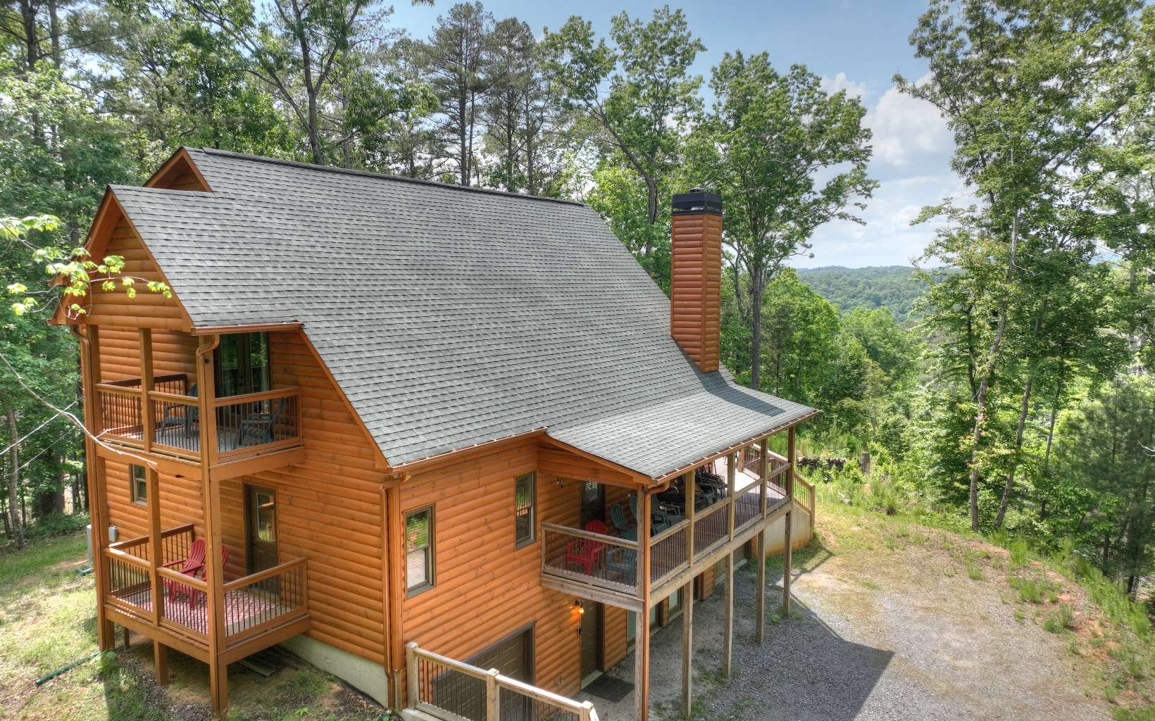 ONE OF A KIND FULLY FURNISHED 2017 CABIN WITH LONG RANGE YEAR ROUND MOUNTAIN VIEWS! If privacy is what you are looking for, this cabin includes 3 lots for a total of 2.58 acres! Features include 2128 square feet, 2 large bedrooms, 2 1/2 baths, vaulted ceilings, open floor plan, granite counters throughout, tile showers, beautiful tongue and groove throughout, a full unfinished basement framed and plumbed for 2 bedrooms and 2 full baths, 2 deep garages, a covered porch area, large deck, covered porches off of each bedroom, and a large yard. This lot does have a small view of Carter's Lake and could have a better view with tree trimming. Enjoy the beautiful sunsets over the North Georgia Mountains! All this in a gated community with amenities for the entire family to enjoy that include 3 pools, an indoor pool, tennis courts, river access with covered pavilion/picnic area, fitness center, duck ponds, tubing, and more!