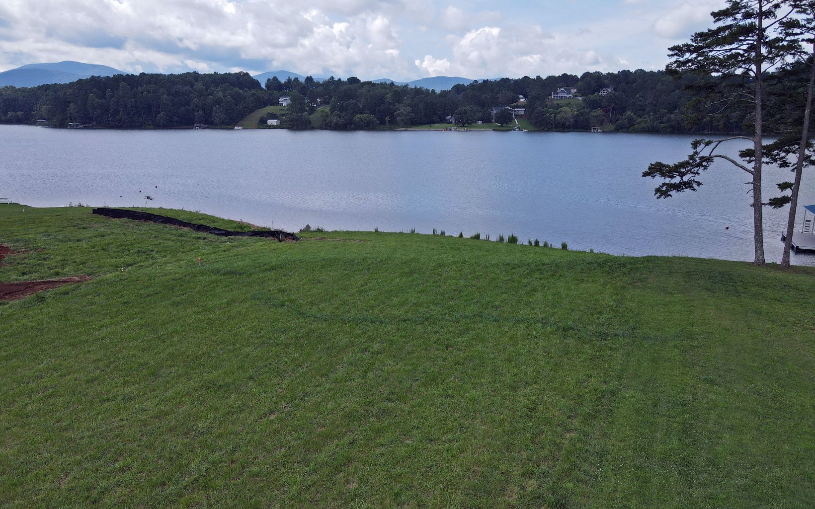 This gorgeous lake lot in the North Georgia Mountains offers year round mountain and lake views. Gated, upscale community in a great area located within three miles of Blairsville, shopping, dining, and schools. Paved roads, underground utilities. Gentle 2 acre lot with very little preparation to build your perfect mountain home. Subdivision offers club house with an infinity pool overlooking Lake Nottley, game room, and marina. Beautiful homes, beautiful views, and a quiet and peaceful community with all the amenities of city living.