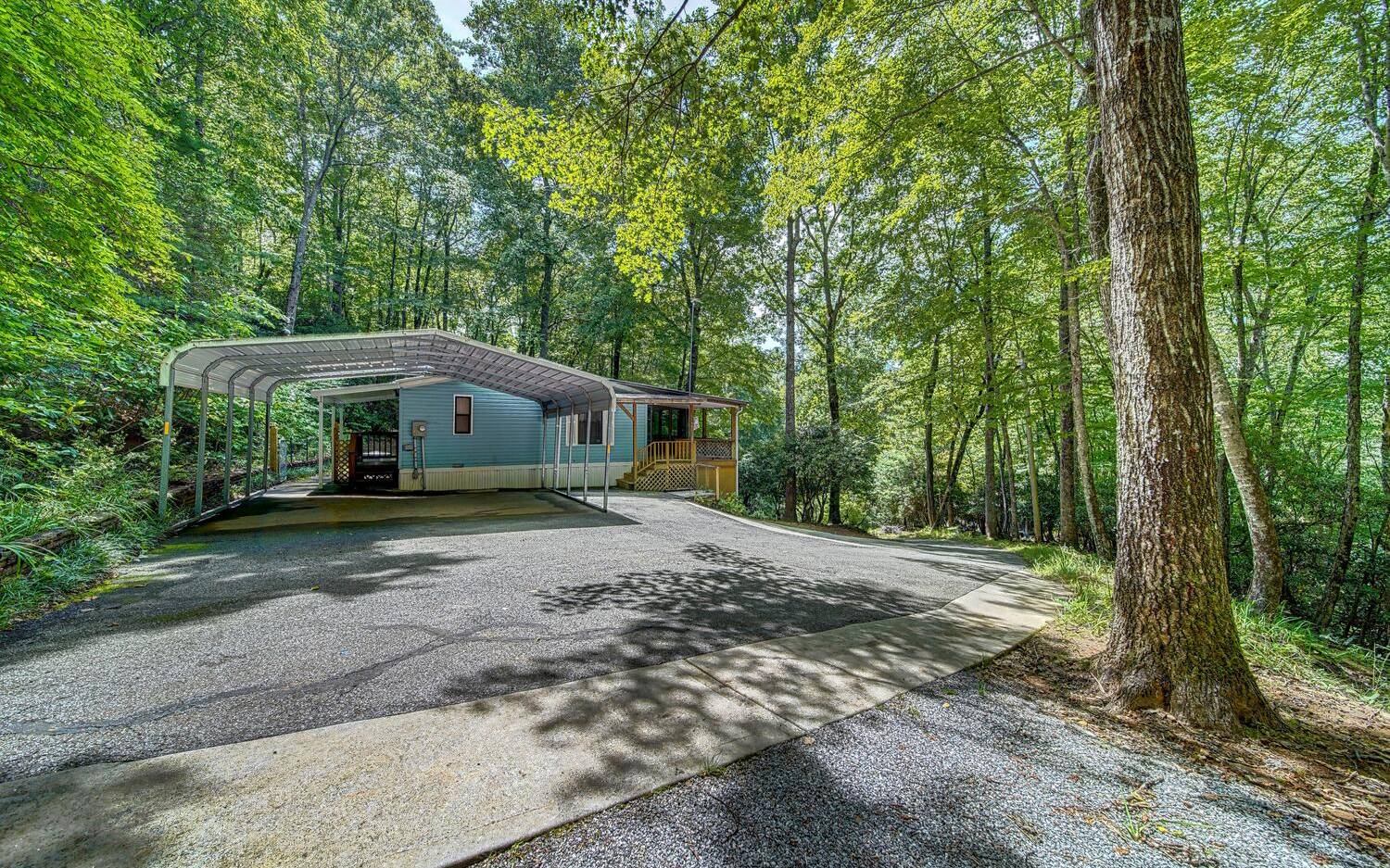 Super clean and neat 2BR/2BA manufactured home on 1.87 acres that Fronts US National Forest Property. Paved all the way to the home. Listen to the waterfall that is on this property that you can hear from the large screened porch. This home has Central Heat & AC new in 2020, newer SS Appliances, laminate floors and new fixtures, fans,sinks and Toilets. Very private location is quiet and like being in a treehouse. Seasonal Mountain views. You will LOVE this wonderful getaway place or live in it full time. Small workbench under deck, fenced dog area and storage shed. Selling CASH ONLY and " As Is"