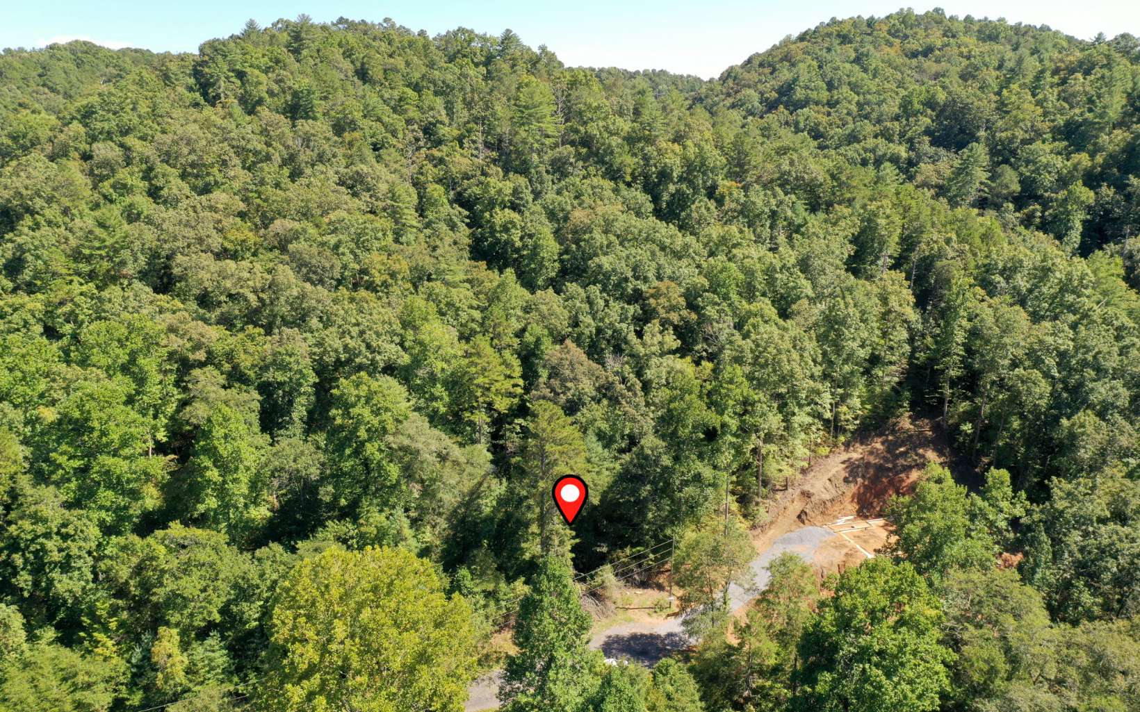 Enjoy the wonders of the North Georgia Mountains and build your dream mountain home in the gated Talking Rock Creek Resort! This 3.88-acre lot is less than 500 feet from Talking Rock Creek and would be perfect for a cabin with a large deck to enjoy the gorgeous mountains and listen to the sounds of the creek. This community is just an hour from Atlanta and offers fantastic amenities such as 2 pools, tennis, a fitness center, hiking, foraging, fishing, wildlife watching, and more. Spend the day out on Carter's lake, enjoying the beach, boating, hiking the trails, or take a short drive to visit several local vineyards, orchards, tubing, and charming towns like Historic Downtown Ellijay, Blue Ridge, and McCaysville.