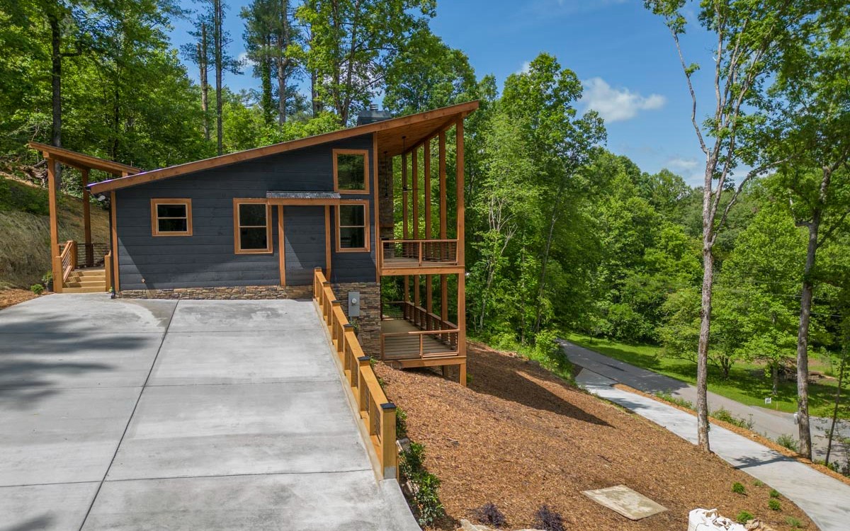 Mountain getaway or full-time living, this home is nestled just 5 minutes from downtown Blue Ridge. With all paved road access, and covered porches to enjoy the view overlooking Pounding Mill Creek. An open floor plan complimented by the high ceilings, custom cabinets, granite countertops, wet bar, & stainless appliances. This modern mountain home is perfect for you!
