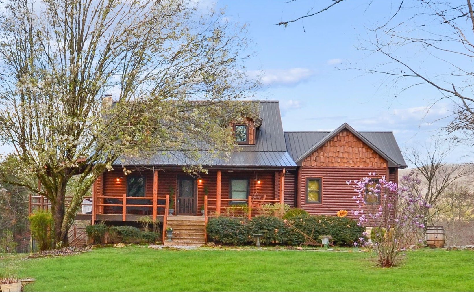This fully renovated rustic lodge with 4 BR and 3 1/2 baths, a state-of-the-art horse farm, and 5 star fully furnished barnominium vacation rental (with income of $30K+) has it all with pasture and long range views from both properties! Fall in love w/ the lodge style living room w/ vaulted ceiling, wood accents, antler chandelier, branch railing, & masonry fireplace. The cabin also features a spacious kitchen w/ exterior deck overlooking the farm, a perfectly planned master bedroom, dream closet, master bath w/ gorgeous petrified wood & flagstone floors, an upstairs loft w/office space, a sleeping nook, and an additional bedroom with bath. The basement includes an additional family room and 2 bedrooms. There is also a planting room & stone patio w/ fire pit. Bring all the animals, as this property is complete w/ a 3 stall horse barn, fencing, tack room, outside horse wash, entertaining kitchen, & more. Above the barn is a 1 bed/1 bath open floorpan 5 star vacation rental fully furnished. Extra bath in lower barn.