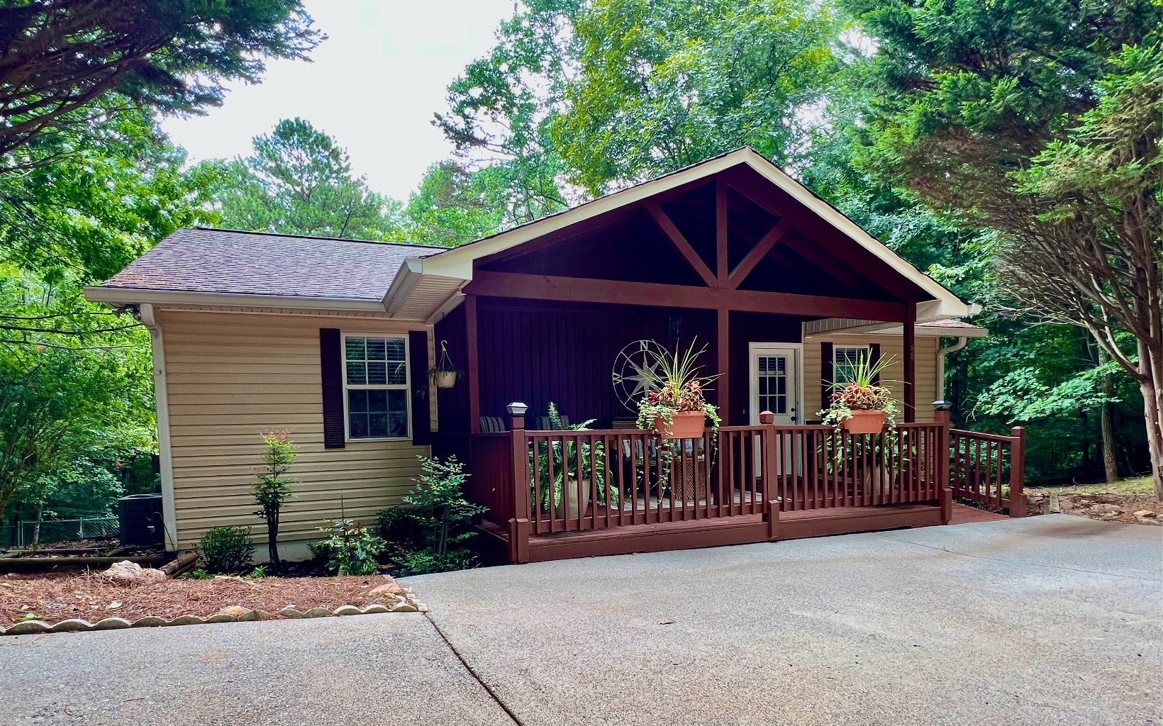 Price improvement!! NEWLY RENOVATED RANCH CABIN only minutes from Downtown Ellijay! This beautifully renovated home has two beds and two full baths on the main with refinished pine floors, new stainless appliances, granite countertops, vaulted ceilings, and a gorgeous corner gas log fireplace. Open concept from kitchen and dining into living space. Ramp entry and everything (including laundry) on main level for easy one-level living. All paved circular drive with a side strip of additional parking. Back deck is perfect for grilling, with an additional screened porch attached. New 3 ton HVAC. The vaulted open and inviting front porch is a great place to relax and enjoy the wildlife in this calm, peaceful resort. A 3rd bedroom with wardrobe and full bath are in the finished basement, with a flex room that could be a 4th bedroom or living area. Walk out on to the patio from the basement, a perfect spot for a hot tub, and you'll find a gorgeous fenced in back yard with fire pit area, storage building, and small creek in the back! Second half of basement would be a perfect game room, workshop, or additional bedrooms. So many possibilities with this adorable rustic retreat! Enjoy all the amenities of Coosawattee, including three pools, rec center with arcade, fitness room, tennis, basketball, pickleball, and more. Hiking trails, stocked pond and river access for fishing and swimming add to the enjoyment for families and renters alike.