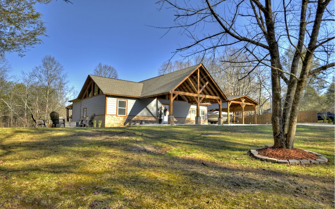 Are you ready to fall in love? This modern rustic style home located in the heart of Morganton might just be “the one!” This new construction southern charmer is just a stone’s throw from Hwy 515 making it just minutes from downtown Blue Ridge and Blairsville and an easy trip to all your heart desires in the North Georgia Mountains (and easy for travelers from abroad, too!) This “home sweet home'' offers one level living with four bedrooms and three bathrooms, as well as a loft. It has the perfect blend of textures - drywall and wood with stainless appliances, custom cabinetry & tile throughout, and modern fixtures. It is complete with spacious decks to enjoy outdoor living, a firepit, 2 car carport, concrete drive, and spacious gentle yard. This beauty is one you don’t want to miss! What are you waiting for - let’s play matchmaker!