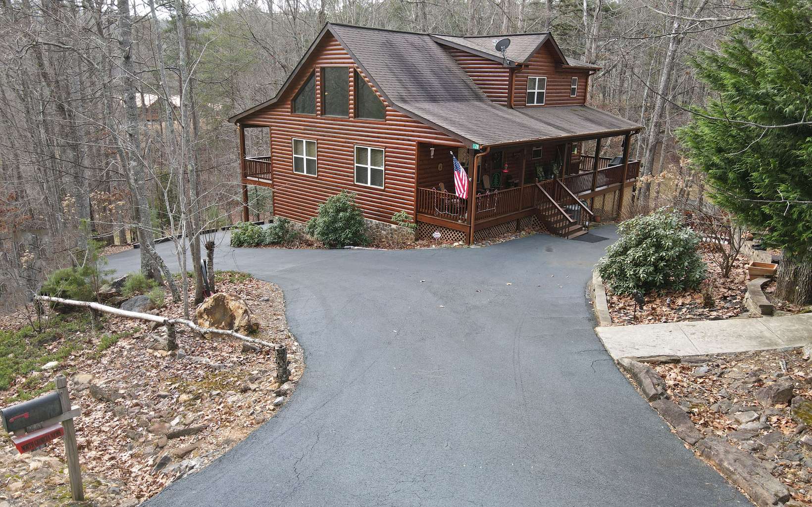 AMAZING ABUNDANCE in this LOG sided home on 4.95 Acres! Great room sizes and beautiful wood floors and ceilings, nice mixture of drywall and wood. Stone Fireplace, Masters on every floor. Full additional kitchen in lower level, lots of storage areas. Detached 2 plus garage with Bonus/Bedroom above with half bath. Wrap around porch, fire pit area, with exceptional landscaping. Bring all your lake toys, close to Lake Nottely and marina. Perfect areas for guests or live in family!