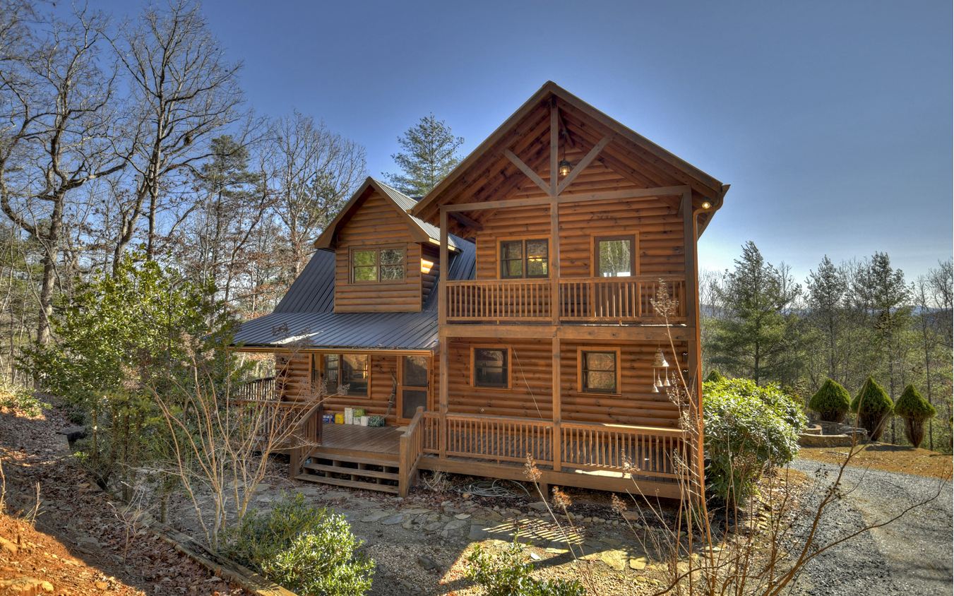 Life is better at the cabin... This true log cabin is just what comes to mind when you think of your mountain escape. Located in Mineral Bluff, this charming retreat is convenient to both Blue Ridge, GA, and Murphy, NC, with all of your needs and wants at your fingertips - entertainment, dining, shopping, medical facilities, schools and more! This cabin offers 1BR/1BA on each level, all wood interior, soaring cathedral ceilings in the great room, open living room and kitchen, cozy fireplace in the great room, game room, fantastic view, fabulous outdoor firepit, and a generous lot for privacy and room to roam. With three levels of living, there's room for everyone from the upstairs with private balcony to the full finished basement, and more! Whether you’re considering full-time living, a rental investment, or your private getaway, this retreat will have you enjoying the mountain life in no time!