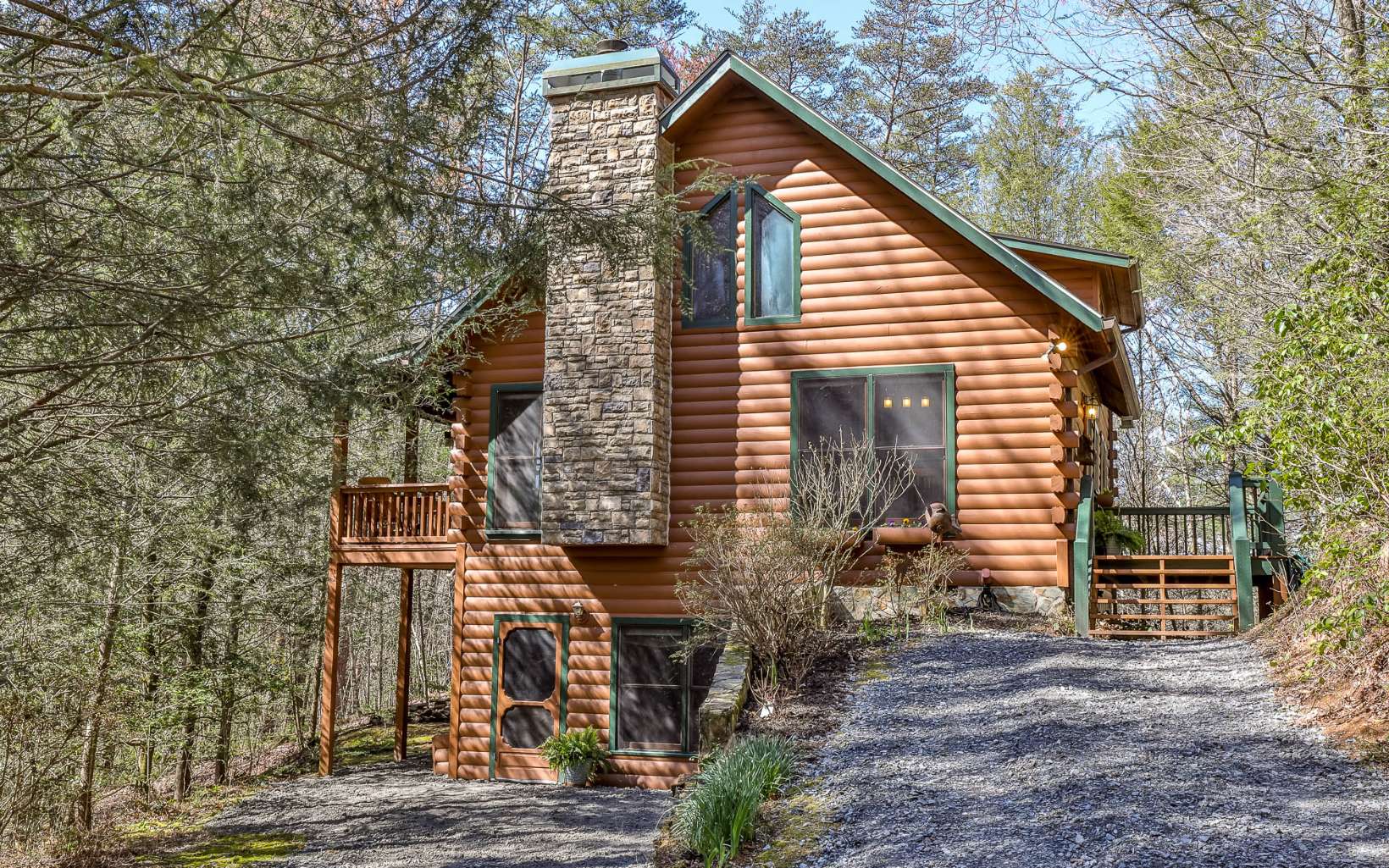 Back on market no fault of seller. This property is adjacent to the Rich Mountain Wilderness and Rock Creek, creating a private sanctuary on 1.65 acres. Perfect as a vacation home or primary residence. Sit outside and listen to the sounds of Rock Creek as it soothes your cares away. This is a custom built all wood log cabin with 3 bedrooms and 3 baths. Spend cozy days and nights next to the fireplace in a living room that has soaring ceilings and beautiful extra wide pine floor planking. Exposed beams grace the entire main floor. Antique mantel from 1800's. The kitchen has been updated with new granite countertops and and light fixtures. The primary bedroom is on the main floor and has a full bath. There's a extra large bedroom with full bath in the upstairs loft. The finished terrace level has a bedroom & bath, playroom or additional living/sleeping space. Enjoy the outdoors in comfort from the deck or porch. This is the perfect location between Ellijay and Blue Ridge. There is no HOA.