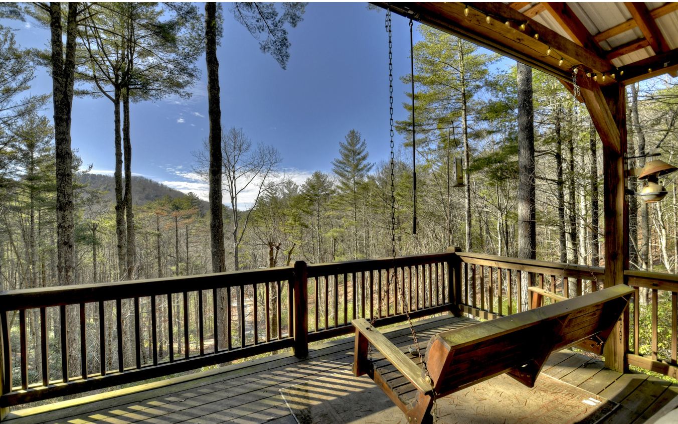 FANTASTIC LOCATION.....Aska's STANLEY CREEK Area..... "Furnished" w/Long Range Mtn. Views of Rich Mt Preserve within WALKING DISTANCE distance of the Long Branch "WaterFall" & 3 Major Hiking Trails inside 28,500 Acres of National Forest. Open Gable "Glass" on BOTH Sides of this Impressive Chalet w/Cathedral Ceiling, Hardwood Flrs & Stone Fireplace (Wood-Burning w/Gas Logs). Kitchen features Granite Countertops/Backsplash, Gas Stove & Wine Cooler. (2) Huge "Slate Tile" Showers (Frameless Doors), Tile Flrs & Raised Granite "Double" Vanities in (2) Baths. (2) Bdrms on the Main Floor w/Screened Porch off Great Rm. Spacious Upper Level "Full Suite" w/Impressive Slate Shower. Finished Terrace Level w/Wood Ceilings offering Bonus Rm, Huge Laundry/Storage Rm (2nd Refrigerator) & Full Bath. Terrace Level Covered "Party Porch" w/Exterior Fireplace/Dining Area & Hot Tub. Beautiful Stained Glass Fixtures & Antiques Included. Small Rustic Community of only 7 Homes (Vacation Rentals Permitted). Established Area of High End Properties w/an Amazing Approach along the Toccoa River & Stanley Creek. Detached Garage/Carport w/Paved Driveway.