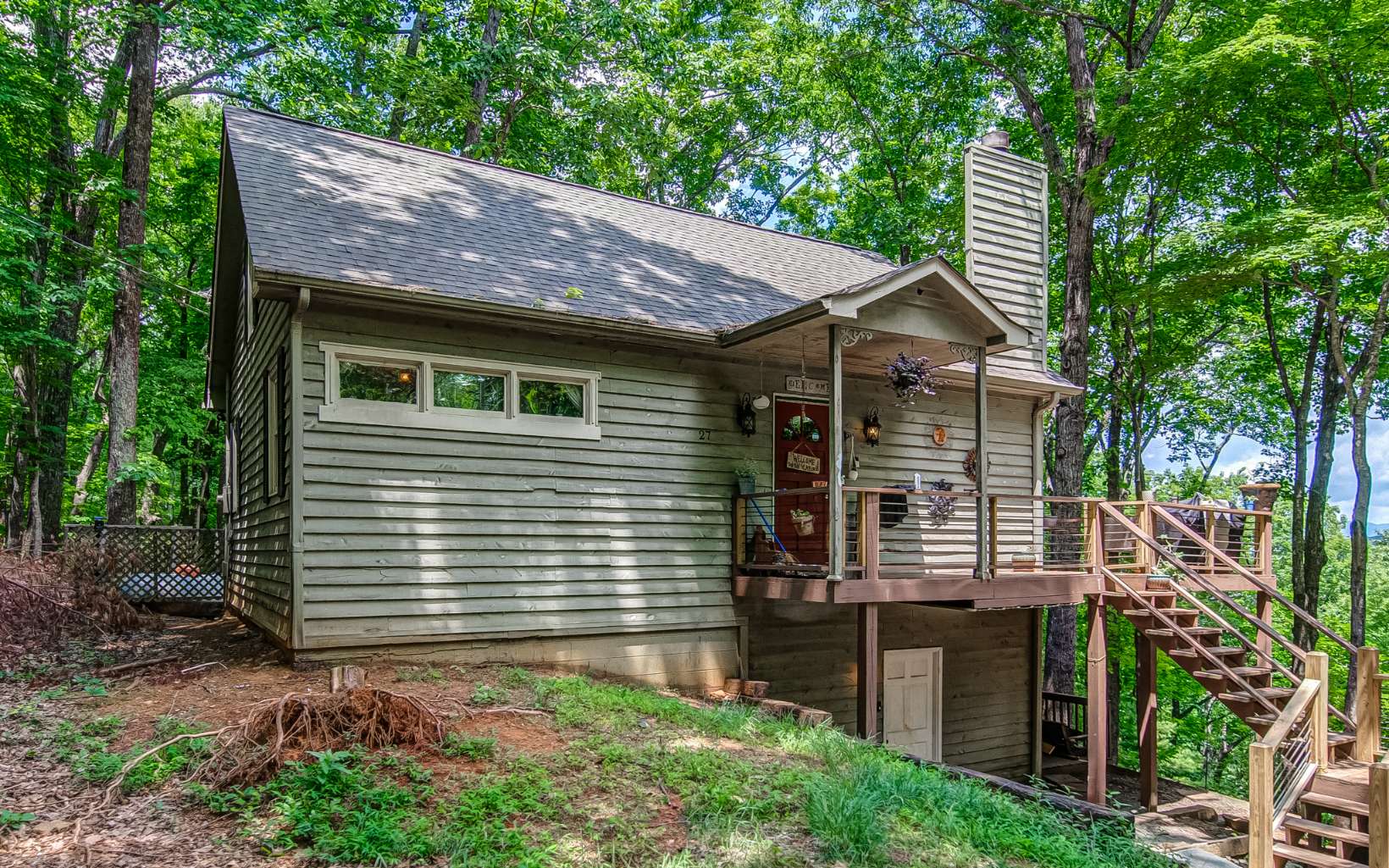 You do NOT want to miss this opportunity! Beautiful cabin in the highly sought after Walnut Mountain community of Ellijay, GA is now available. MILLION DOLLAR views of the North Georgia mountains. Be prepared to have your breath taken away! This home is ready for you to come in and make it your own. Sizable double lot, means you never have to worry about losing the serenity and peace this home has offer. Easy access to the front of the neighborhood, offers a quick escape to the neighborhood's numerous amenities. Extra long driveway and expansive parking pad provides plenty of parking capabilities and an opportunity to host dozens! Newly updated porch is decorated with stylish and chic rebar, well on its way to being the most stylish home in the neighborhood and an envy of all the neighbors. Stunning porch flawlessly wraps around, where you will find the long range mountain views you’ve been looking for! The additional lot being sold, means your view will never be obstructed. Open floor plan living space is adorned with vaulted cathedral ceilings and extra large windows, letting in all of the natural light you could ever want! LVP flow seamlessly throughout the home, both durable and stylish. Farmhouse finishes have been sprinkled throughout the home, including stunning light fixtures, barn doors, and so much more! Country kitchen overlooks the living space. Kitchen is complete with solid wood cabinets, ready to be sanded and made your own! And stainless steel appliances fini