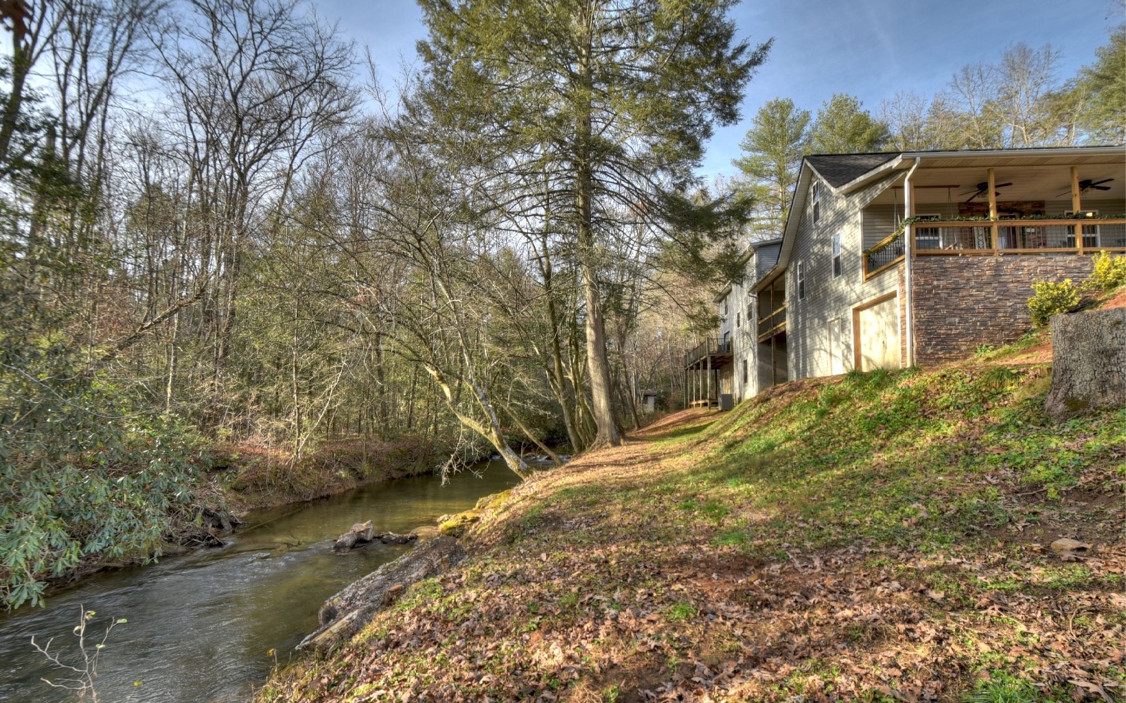 Creekfront! Traditional home with a touch of rustic flare perched above wide Ritchie Creek. Centrally located between Blue Ridge and McCaysville and easy access. Home offers cathedral ceilings, ample living space, large living room to accommodate the entire family, partially finished basement, multiple porches overlooking the creek that runs the length of the property, low maintenance vinyl and stone exterior, and plenty of outdoor area for gardening. Close to schools, medical facilities and downtown shopping!