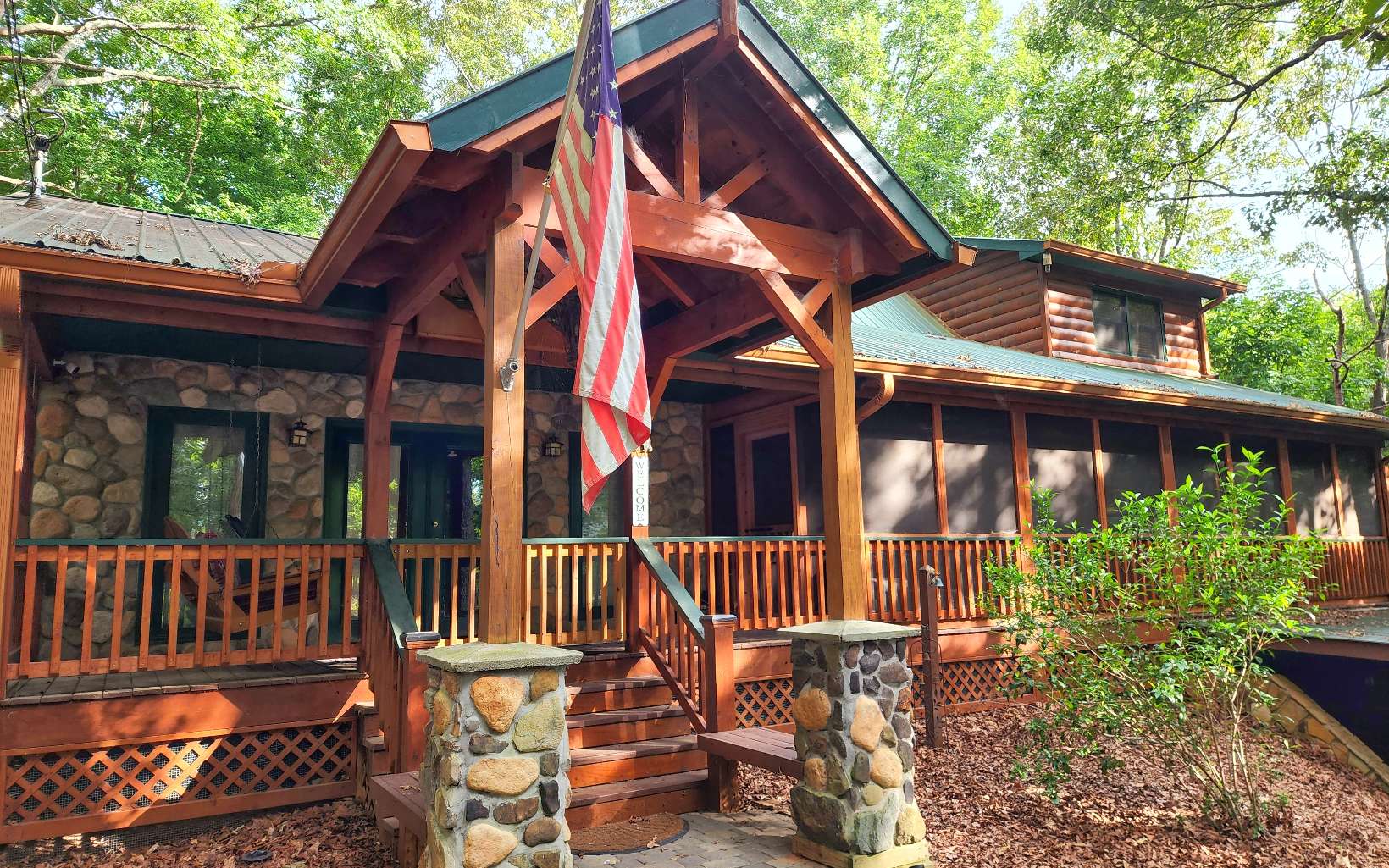 Escape to the North GA Mountains with this 3BR/2BA home. Bonus Room in basement also! Wonderful curb appeal, perfectly situated on a gentle wooded lot. You are welcomed with a rock entrance & full length covered porch & screened porch. Home features a huge living/family room w/wood burning stove & vaulted ceiling, great for family gatherings. A sitting room with stone fireplace. Renovated kitchen, opens to large deck. Finished terrace level has a bonus sleep room, a game room, 2 lg workshops. 2 outdoor sheds (both have electric, 1 is insulated), fenced in yard, carport. Gated community, close to the gate, less than 5 miles from town. Sold partially Furnished will Provide List. Permitted for a 2 bed septic. Septic cleaned 2021.