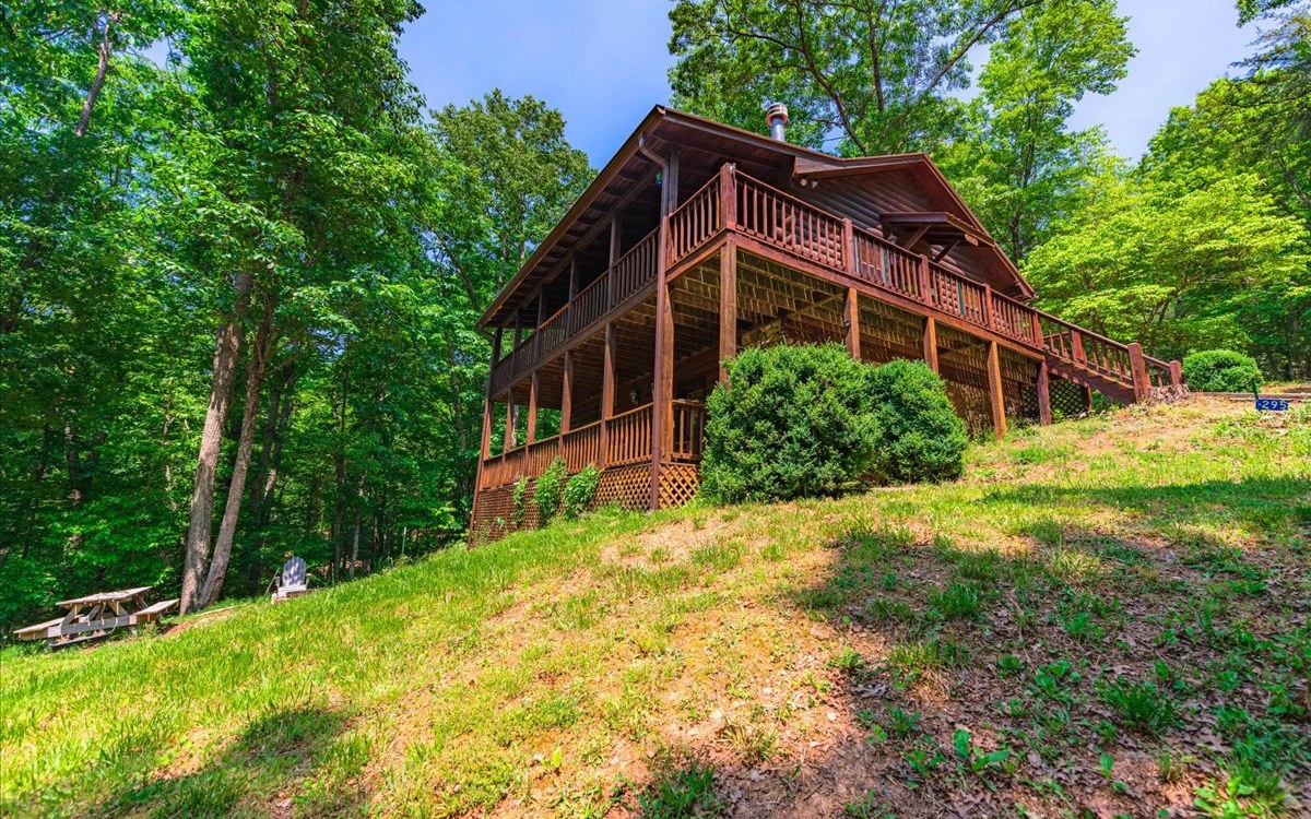 "New Appliances On the Way" (Vacasa management comps show potential rental income in the 60,000 gross+ range) Don't Miss out on this Rare Opportunity!! Aska Adventure Area !! Short term rentable Log Cabin less than a mile to Toccoa River canoe launch/ beach area. Long Range Mountain Views from this 3/2 cabin, NEW Metal Roof & Gutters "guaranteed for life, transferable warrantee", 3 bedrooms & 2 full baths, large kitchen w/dinning room & great room on main level w/wrap around covered porch. Guest bedroom and full bath in finished basement with additional kitchenette along with terrace level porches. HVAC less than 3 years old , Plenty of parking, easy access & surrounded by USFS property near end of road privacy w/no real close neighbors. Large fire pit area, abundant wildlife, close to the Toccoa River, Lake Blue Ridge, hiking & biking trails, and a scenic drive to downtown Blue Ridge. Cabin has rental history from previous years not currently on rental program, most furnishings included, turn key ready. Furnishing available with separate bill of sale.