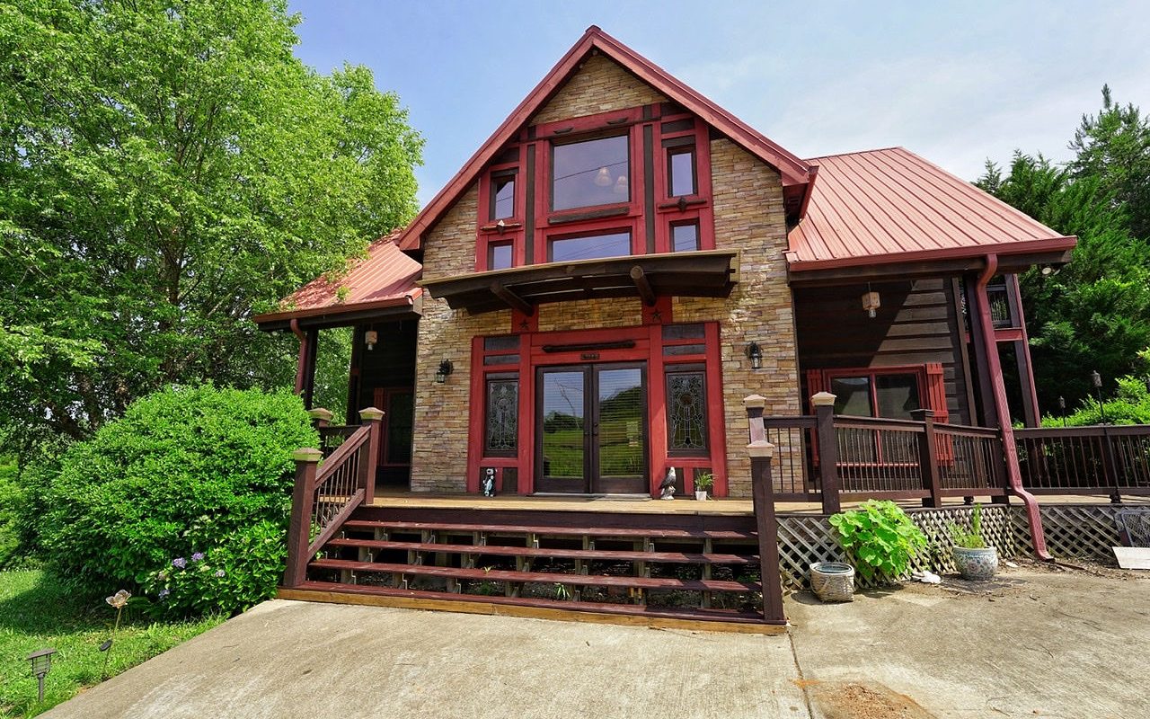 PRICE REDUCED! Living large in the mountains w/room to spread out w/family getaway vacation home/vacation rental or full time living. Exceptional rustic home offers a sprawling interior & incorporates large entertainment spaces on 3 levels, expansive great room w/gas logs in the fp, home office, sauna, bonus room & even a safe room plus 640 sq. ft. storage bldg. Spacious & inviting w/chef-inspired beautifully, maintained kitchen & boasts gleaming appliances & granite countertops. Well-maintained wide-plank floors throughout the main living spaces. The comfortably sized main floor master is a secluded retreat w/bright & cheerful ensuite bathroom, large closet. Two spacious bedrooms upstairs with sitting area & two terrace level bedrooms & full bath. Covered wrap around porches w/cozy hang out spots to relax & escape. Relax in this enormous mountain getaway that has lots of space for gatherings and outdoor entertainment.