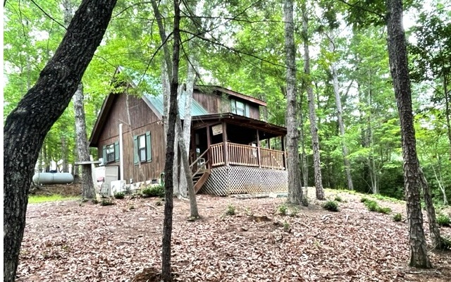 Rustic cabin in the woods. Partially furnished. Open floor plan on the main with a gas log fireplace. New kitchen appliances, water heater and mini split HVAC unit. The open loft offers a bedroom and half bath. Covered porch.