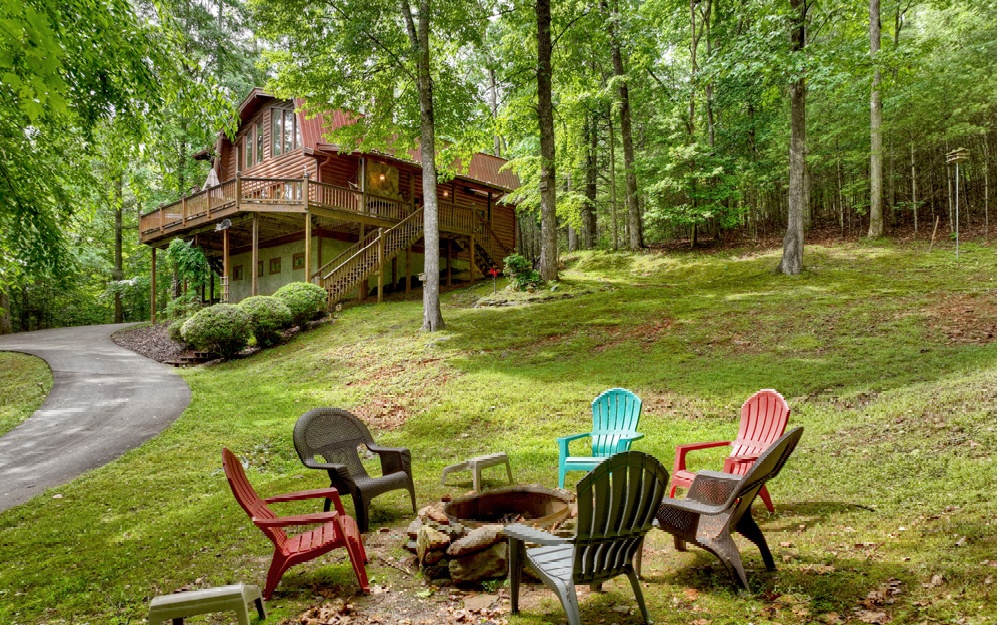 Aska Adventure Area Private Retreat within walking distance of USFS on 3 unrestricted acres! Listen to the sounds of Big Creek from the porches of this 3br/3.5ba cabin w/plenty of space, 2 car basement garage, concrete circular driveway, 2 levels screened porches + additional open porch & large deck complete w/hot tub! Soaring cathedral ceiling w/massive wall of windows for tons of natural light, stone fireplace. Master & laundry on main, spacious updated kitchen w/gas range, beautiful exposed beams throughout, tasteful mix of wood finishes/wood floors. Amazing location in the middle of all the hiking, mountain biking, & trout fishing. Peaceful mountain retreat offering tons of wildlife nestled into the Chattahoochee National Forest! Could have year round Mtn. view w/tree trimming. Fully furnished. Current successful short term rental.
