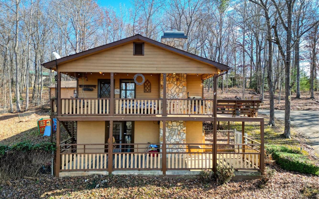 Here's your chance to have an affordable vacation getaway home! Nestled in beautiful Blairsville, GA and less than 10 minutes to public access on gorgeous Lake Nottely! Easy access with paved roads lead you to the paved driveway, motorcycle friendly! Home features a pretty seasonal mountain view, open floor plan with nice size kitchen. Large wood burning fireplace in living room. Main floor has two bedrooms & 1 bath. Finished basement area has third bedroom & second bath as well as a den/office space. Laundry is in the basement. House has nice decking off the main level and patio on basement level. Detached 1 car garage. Side yard is fenced for your fur baby! Roof is approx. 10 years old, HVAC is approx. 7 years old! Great walking neighborhood with minimal restrictive covenants. Check this one out before it's gone!