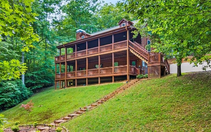 Fantastic mountain dream home now available! Whether you are looking for that perfect getaway or an awesome income producer, this Fannin County beauty fits the bill. Impeccably cared for 4 bedroom, 3 bath cabin with both small pond and creek frontage. 3 levels of luxury living with recent upgrades including; fresh stain on home and deck, new water heater and stove, and septic pumped with risers installed. Oversized 2 car garage adds to the functional possibilities. Listen to the sounds of the flowing creek from either of the decks or the wonderful firepit area. Turn key ready to go with high end furnishings, pool table, built in murphy bed, hot tub and outdoor furniture. Everything you need to start enjoying the serenity of this location right down the the dishes. Home also has an impressive rental history. All this plus the ultimate in convenience as it is less than 1 mile off of 515 and it's location of halfway between Blue Ridge and Blairsville makes seeing all of the attractions of the North Georgia Mountains convenient to access. Make plans to see this one today before it is gone.