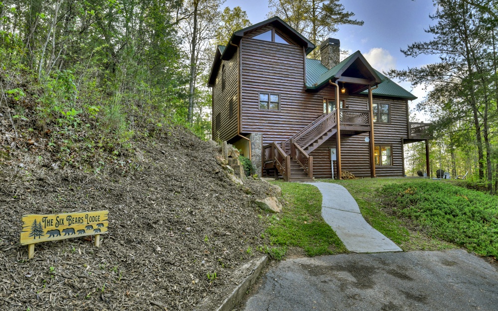 Amazing Rental House!! Welcome to The Six Bears Lodge, a 4 Bed/3 Ba Fully Furnished Turn-Key Rental cabin located exactly where you want to be - Less than 3 miles from Downtown Blue Ridge on a paved road with no HOA. Currently set up to sleep 10+, this home boast a large floor to ceiling wood burning rock fireplace and was made for entertaining with its well-apportioned main level trimmed in Log and Mountain Laurel, gaming area located in the basement, and ample decks for outdoor living and dining. If desired, some light "vista pruning" will bring out the 180 degree mountain view. This cabin grossed approx 30k in the last 6 months of 2021!!!