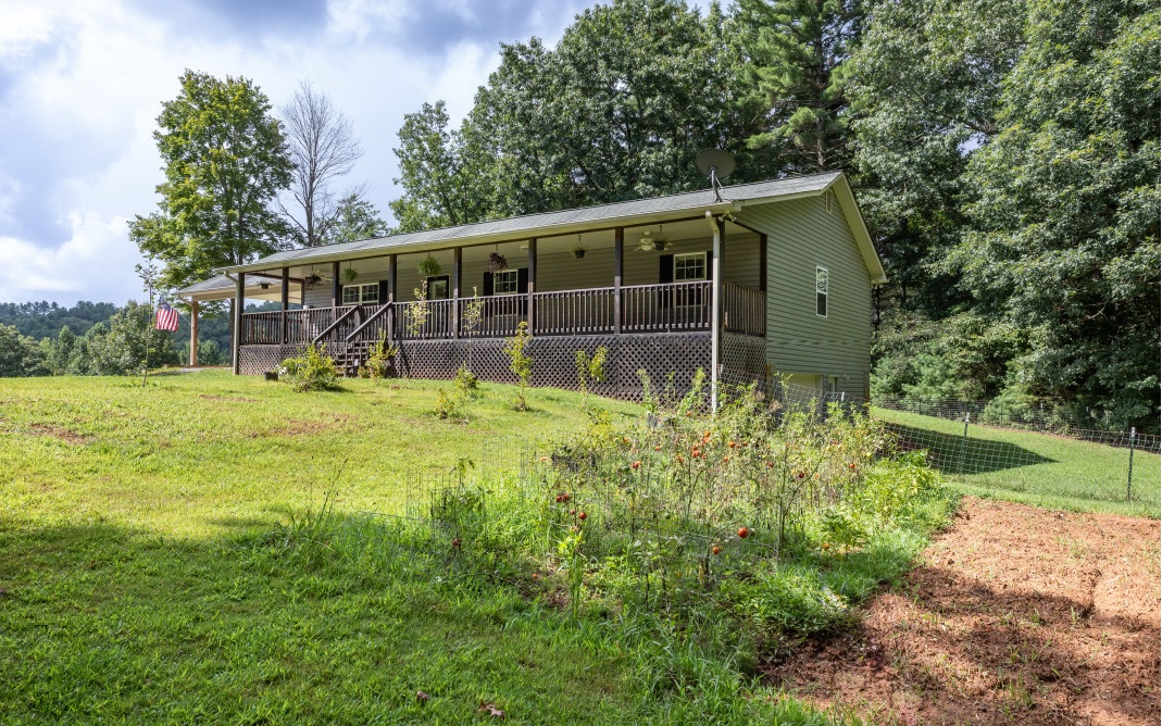 Enjoy over 10 acres of private land, your own creek w/ mountain & pasture views, and 1664 sq ft of living space. Currently used as a mini-farm with multiple fenced-off areas plus an outbuilding/workshop, stall barn (elec/water) & loads of potential for gardening! Perfect place for horses! Open concept LR/DR/Kitchen w/ island/brkfst bar, stacked stone LR FP, vaulted/wood paneled ceilings & walls, hardwood floors, granite countertops, plenty of kitchen cabinets, & rocking chair porch. Added features: central vac system & whole-house attic fan. 2 BRs with full hallway BA/laundry. Owner’s suite w/ walk-in closet plus en suite with walk-in shower & oversized vanity. Unfinished basement w/ HVAC, plumbing for extra bath, 1-car garage & loads of storage. 1.5-hr drive to ATL/CHATT. Close to Ocoee whitewater rafting & USFS service roads/Cohutta Wilderness for miles of riding/hiking trails.