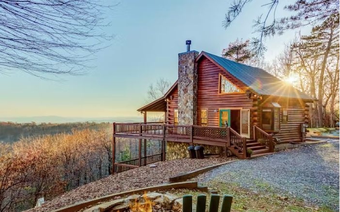 The sky is the limit… this breathtaking rental cabin is the ideal turnkey investment. Perched above the clouds on 6+ private acres, this cabin and the endless possibilities are simply unmatched. You’ll, of course, delight in the stunning view - both sunrise & sunset you’ll want to be outdoors soaking it in! Best of all - you can enjoy this view from all three levels. You’ll appreciate ample parking, gated entrance, & plenty of room to roam/room for expansion. In addition to the view, the mostly wood interior showcases what the rustic mountain life is all about. The floorplan unites the kitchen, dining, and living room areas - the perfect place for gathering. Whether loved ones or valued guests, there’s plenty of room for everyone on all three levels. This dream retreat is situated between the charming towns of Ellijay & Blue Ridge for entertainment, dining, and more, and, when you’re finished, the cabin is the prime location to return to soak in the atmosphere and enjoy some peace & quiet. Whether you’re looking for a place of your own or to add to your portfolio, this is one you can’t afford to miss!