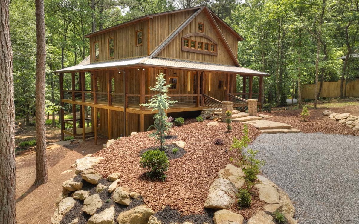 Introducing "Creekside Retreat," a charming new home built by TimberWood, Inc. This thoughtfully designed 3BR/3BTH property sits on 1.97 acres alongside Turkey Creek, boasting 221 feet of creek frontage. Enjoy the tranquil ambiance from the wrap-around covered porch. Inside, discover circular saw hardwood flooring, a rock fireplace, and an open concept layout that effortlessly connects the living spaces. The kitchen and bathrooms feature granite counters, custom-designed lighting fixtures, and stainless steel appliances. Meticulous attention to detail is showcased in the use of repurposed barn wood, pine, live edge trim, industrial accents, and custom-made barn doors. Abundant natural light streams in through large windows. Outside, you'll find a well-crafted fire pit area and professionally landscaped grounds with natural ferns and rocks. Located in an unrestricted area, this retreat offers freedom and flexibility for full time living or an amazing and unique experience as a vacation rental. Buckley and Ott Vineyards are within 1.5 miles, and downtown Ellijay, with its restaurants and shops, is just a short distance away.