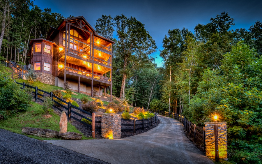Follow the paved drive to this luxurious cabin to take advantage of the large wall of glass windows & doors throughout the log home that captures the beauty in the landscaping as well as a grand mountain view! This marvelous modern, rustic home offers a gourmet kitchen with s/s appliances & open floorplan to the great room featuring a stacked stone fireplace. Once parked in the garage, unwind & enjoy evenings sitting by the exterior fireplace, soaking in the hot tub on the terrace level, or playing a game of pool. Be amazed by the multiple balconies, stone fireplaces, beautiful wood finishes & attention to details of this stunning home. It is ideal for full-time living or as a 2nd home/investment property. Located in an upscale, gated community, in any season you will find yourself mesmerized by the spectacular, awe-inspiring & breathtaking mountain scape. This is one sight you do not want to miss!