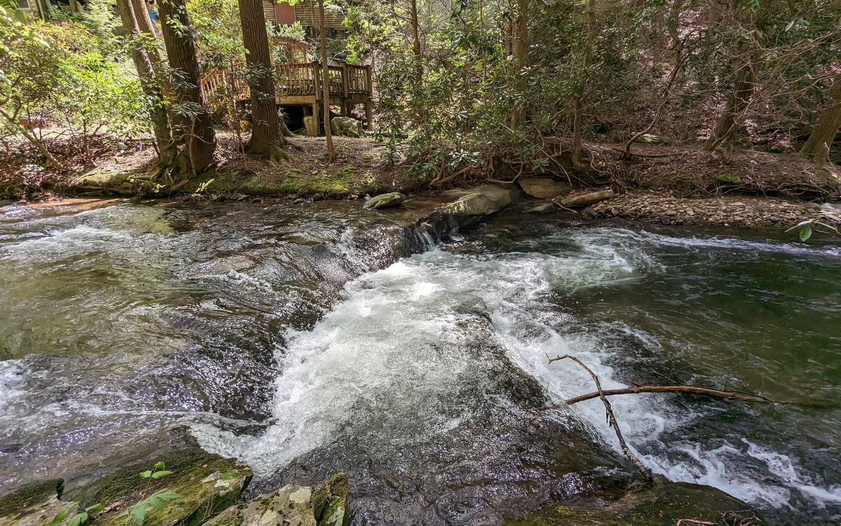This fantastic roaring whitewater lot on Turniptown Creek is available for your future mountain escape. Fish in the same water where former US President Carter would go fly fishing and catch native trout. .63 acres of mature wooded land and 80+ feet of frontage make for an exceptional building lot located in the gated Walnut Mountain development.