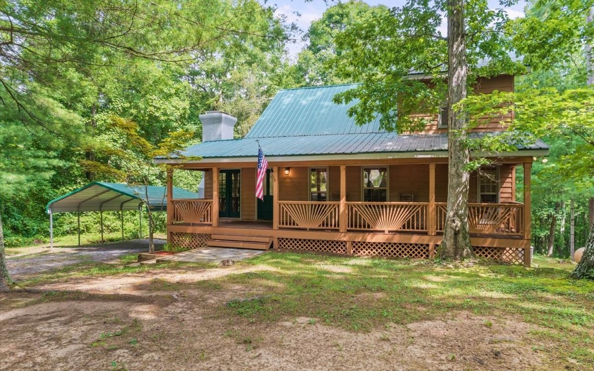MOVE TO WHAT MOVES YOU! This charming cabin style home is the perfect weekend getaway from the city, or a permanent place to call home. The rocking chair front porch welcomes you to sit and enjoy the the solitude of your own private piece of North Georgia. Come in to the open living area that features a Fisher wood stove with custom hand laid river rock surround. The kitchen is complete with brand new stainless steel appliances and opens up to a massive rear deck that spans the length of the home. Access the backyard with ease or just enjoy the privacy and pond view. There are two bedrooms and a full bath with laundry on the main level. Retreat upstairs to the owners suite complete with private bathroom and walk in closet. Ample storage can be found in the attic and half basement. Location is everything and this home gives you the best of both worlds! Just one hour north of Atlanta, and minutes from Jasper and Ellijay. Bring your sense of adventure and see what North Georgia living has to offer!