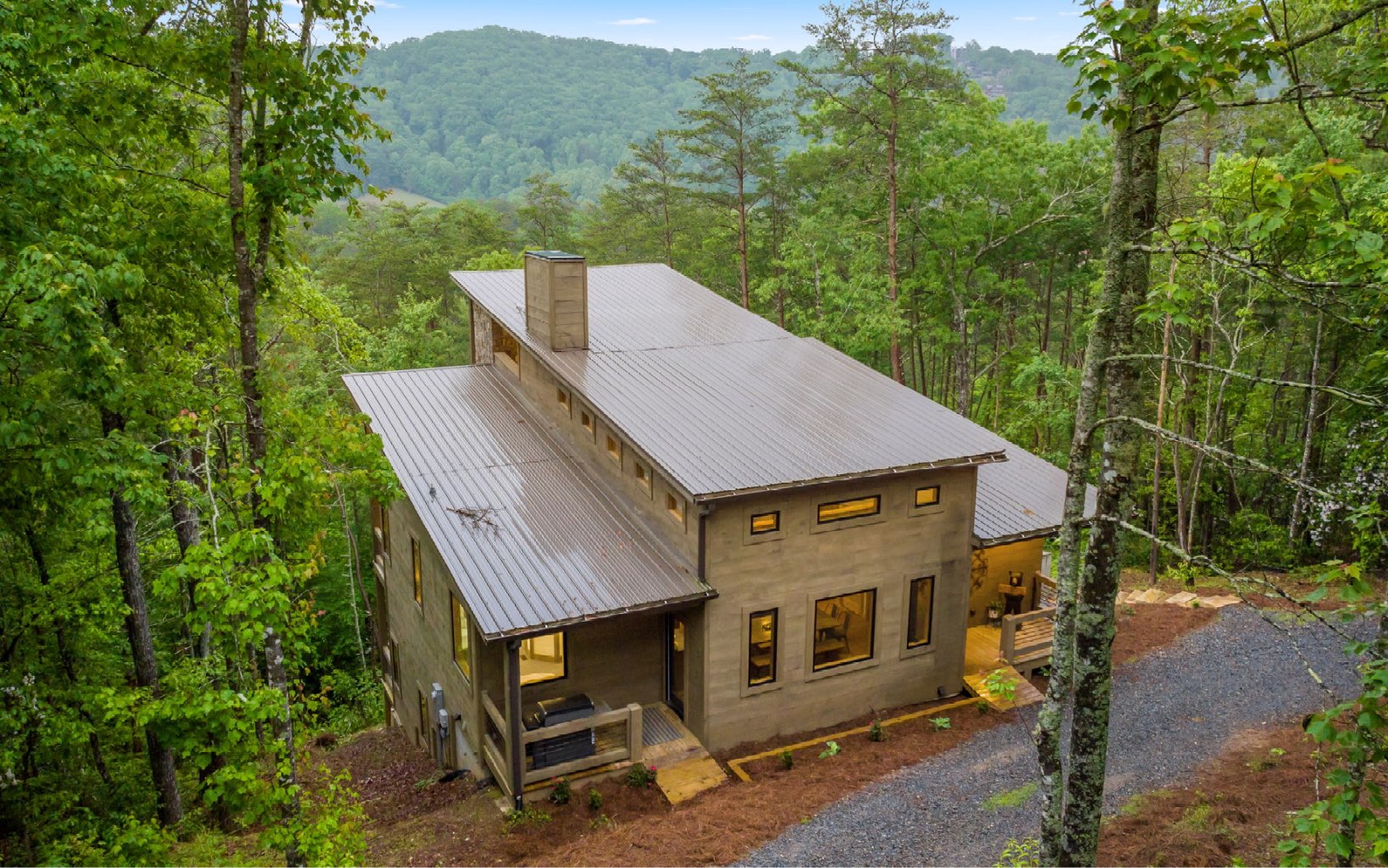Located only 3 miles from downtown Blue Ridge and sold turn key! Step inside this architectural gem and be captivated by the open layout! Iinterior features clean lines, high ceilings, and an abundance of natural light. The finishes and materials lend a touch of sophistication, while still maintaining a cozy and inviting atmosphere.This cabin offers 4 beds/3.5 baths, providing ample space for family and guests. The master suite is a true oasis, with a luxurious ensuite bathroom and private access to the outdoors. Wake up to breathtaking views of the surrounding mountains while sipping morning coffee on the deck. The kitchen is a chef's dream with ample storage and sleek countertops. Entertain guests in the open-concept living and dining area, or cozy up to one of the 4 fireplaces. The cabin boasts an expansive deck that serves as an outdoor living space, ideal for relaxation and entertaining. Soak in the hot tub, take in the scenic beauty, or gather around the fire pit on cool evenings. The property is surrounded by lush greenery and offers privacy, allowing you to enjoy the tranquility of nature. Beyond the cabin's modern comforts, its location is truly unbeatable.