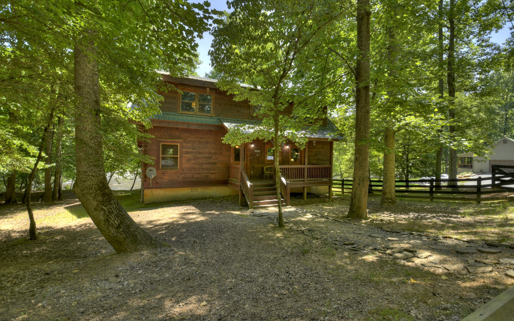 One owner-First time on the market. Custom built log cabin fronting one of the widest parts of the Coosawattee River. Soaring 2 story beamed ceilings in the great room with fireplace. Kitchen with large breakfast bar open to the great room and dining area. Very large master on the main with french doors leading out to the covered rear deck. Master bath with double vanities, free standing soaking tub and separate shower. Upstairs there is a very large loft overlooking the great room with an additional fireplace, 2 additional bedrooms and bath. Sit around the fire pit and enjoy the sounds of the river rushing by. Cabin is at the end of the road so there is no traffic! Successful rental program. Cabin comes turnkey furnished.